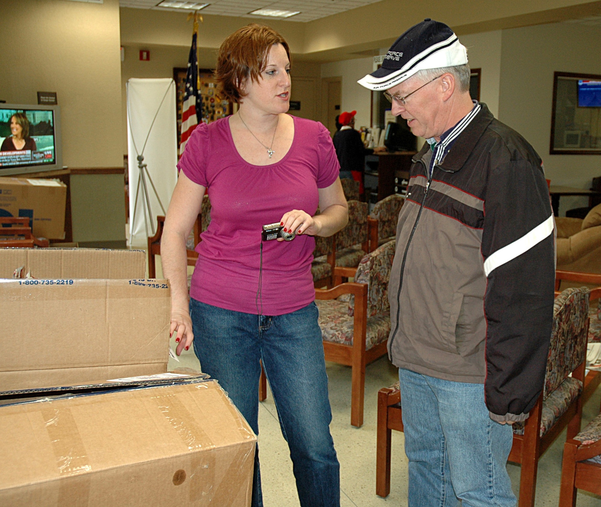 MCCHORD AIR FORCE BASE, Wash., - Traceye Kakely, (left) Puget Sound USO McChord Center, and Carl Supple, director of the 446th Mission Support Squadron's Airmen & Family Readiness Center here, review the boxes of canned goods donated through the Puget Sound USO McChord Center.  Enough food was donated to put in Thanksgiving Baskests for 54 Reserve families in the 446th Airlift Wing. (U.S. Air Force photo/Sandra Pishner)