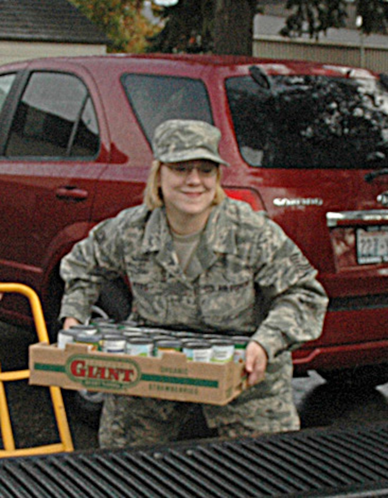 MCCHORD AIR FORCE BASE, Wash., - Tech. Sgt. Suzanne Kyes, 446th Mission Support Squadron's Airmen & Family Readiness Center here, loads a box of donated canned goods onto a truck. The Puget Sound USO McChord Center donated traditional Thanksgiving food for 54 Reserve families in the 446th Airlift Wing. (U.S. Air Force photo/Sandra Pishner)