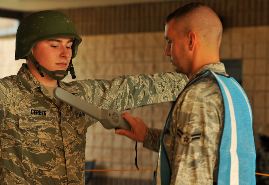 MOODY AIR FORCE BASE, Ga. -- Airman 1st Class David Hubbard, 23rd Civil Engineer Squadron structural apprentice, performs security checks on deploying members during the Phase I Operational Readiness Exercise here Nov. 18. Security checks ensure that individuals entering the deployment control center are not carrying any unauthorized items into the area. (U.S. Air Force photo by Senior Airman Schelli Jones)