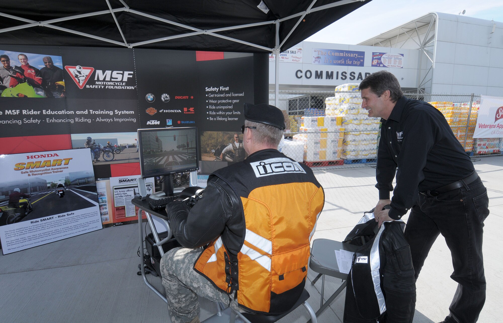 A participant sits immersed in an interactive motorcycle simulator created by the Motorcycle Safety Foundation, Nov. 9. Los Angeles Air Force Base sponsored the 2009 Motorcycle Safety Awareness Day which included vendors, a stunt show and  other attractions. (Photo by Lou Hernandez)