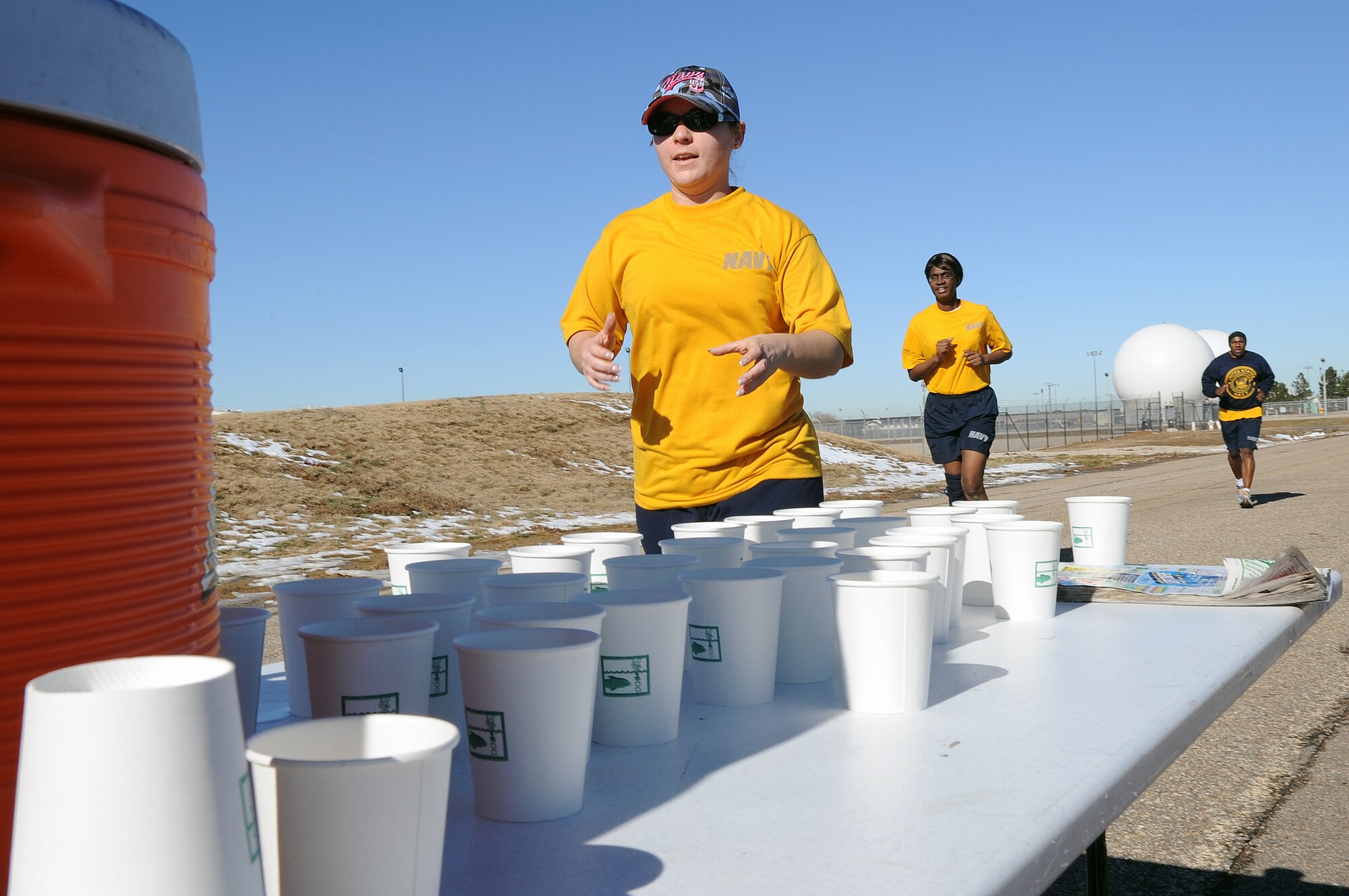 BUCKLEY AIR FORCE BASE, Colo. -- Navy servicemembers stop to get a drink of water during the annual Turkey Trot Nov. 18. A large number of servicemembers and civilians particpate in the Annual Turkey Trot. (U.S. Air Force photo by Airman First Class Marcy Glass)