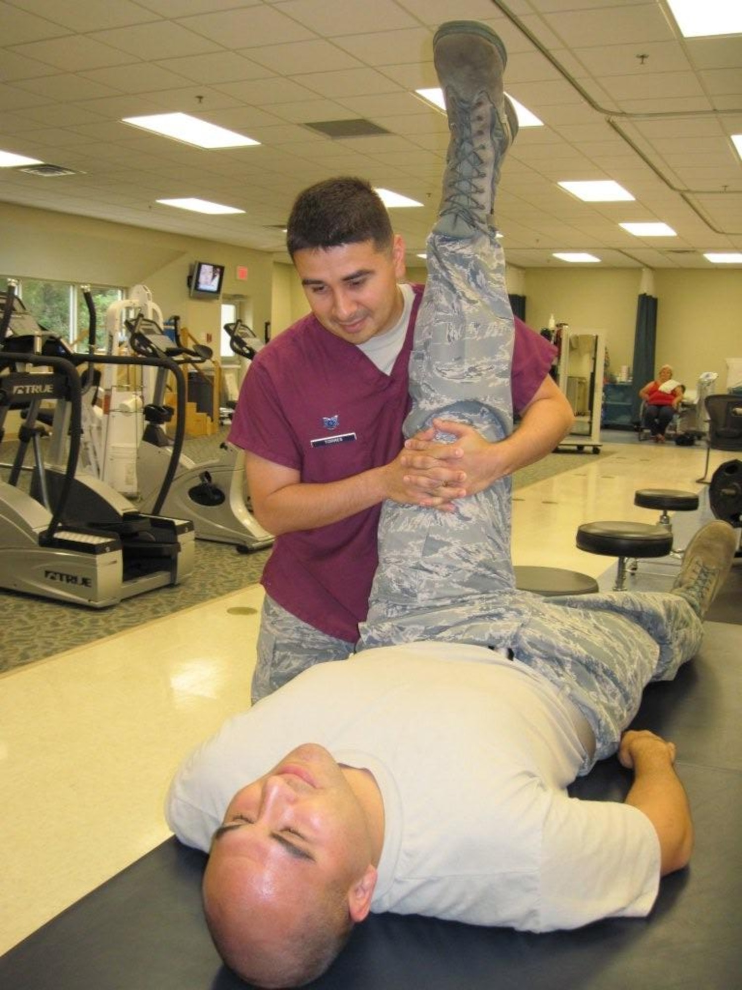 A patient receives physical therapy during a session with Tech. Sgt. Rodolfo Torres, 96th Medical Group physical therapy technician. The team assists approximately 29,000 clients seeking relief from all types of pain. Eglin's staff specializes in several fields including occupational and chiropractic therapies. (U.S. Air Force photo/Minty Knighton)