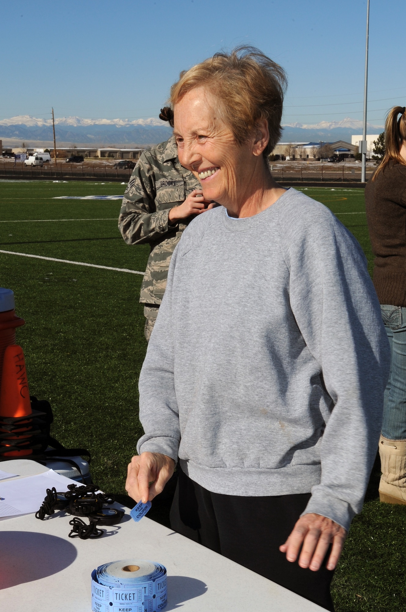 BUCKLEY AIR FORCE BASE, Colo. -- Louis Richard hands out tickets during the Turkey Trot Nov. 18. Mrs. Richard is an Army retiree who volunteers regularly at the Buckley Fitness Center. (U.S. Air Force Photo by Airman First Class Marcy Glass)
