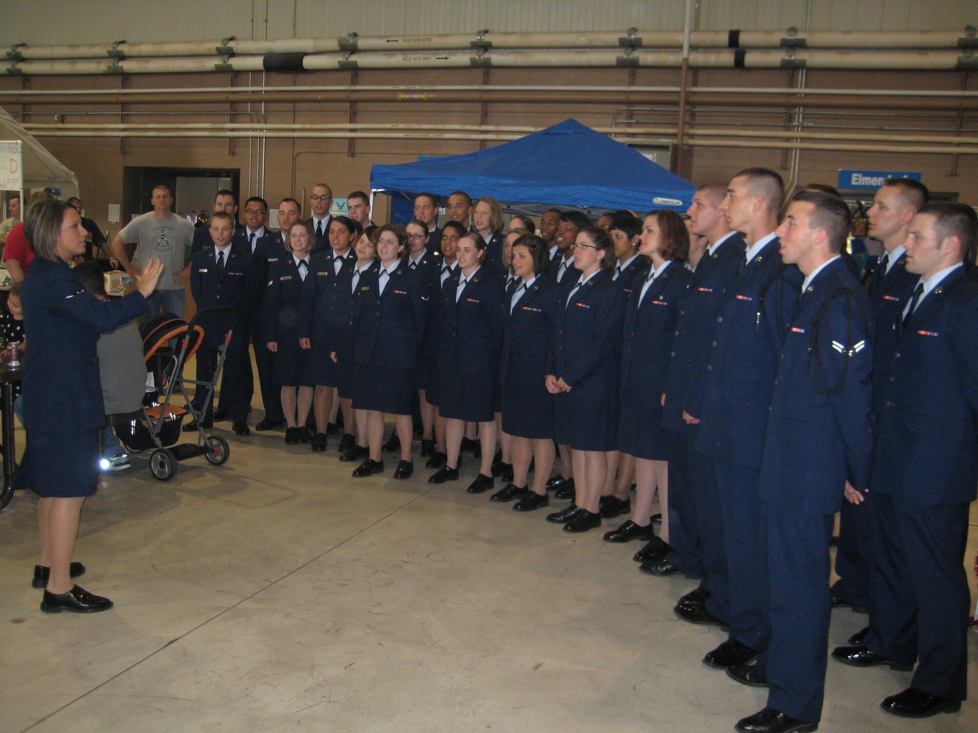The Special Activities Team Choir fill the air with harmonious Christmas music Nov. 14 at the 24th Annual Hangar Holiday. Hangar 1045 was bursting at the seams as more than 14,000 people rang in the holiday spirit. (U.S. Air Force photo courtesy