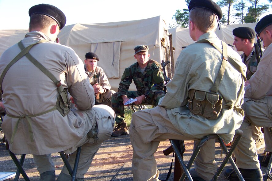 Capt. Kevin Fischer, a combat aviation advisor with the 19th Special Operations Squadron, conducts academic instruction on medical treatment with indigenous forces during the Raven Claw field exercise at the Eglin range Nov. 2. The week-long exercise was a culmination of seven weeks of counterinsurgency doctrine and regional skills training for the Combat Aviation Advisor Mission Qualification Course. (Air Force photo by Airman 1st Class Joe McFadden)