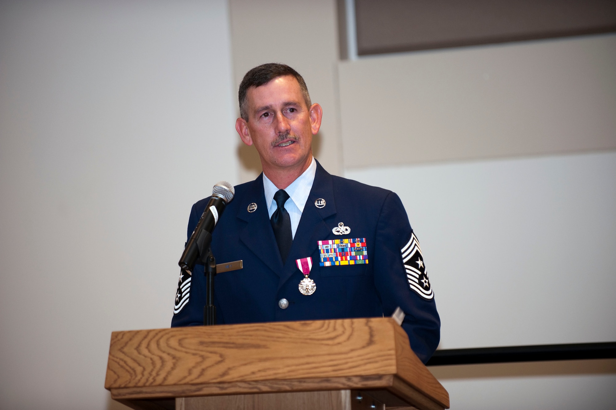 Command Chief Master Sgt. Bruce A. Mey gives his parting words after relinquishing the title of Colorado Air National Guard state command chief master sergeant to Command Chief Master Sgt. Annadele F. Kenderes during a ceremony at Buckley Air Force Base, Colo., Oct 4, 2009. (U.S. Air Force photo by Master Sgt. John Nimmo, Sr.) (Released)