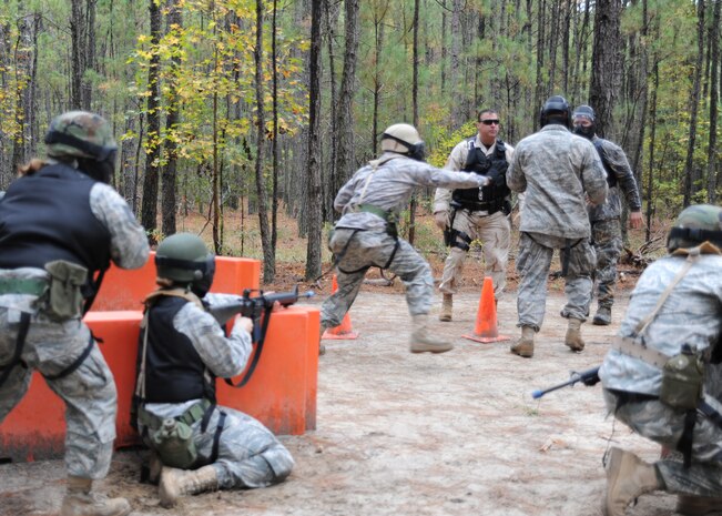 Airmen respond to an altercation taking place outside of the forward operating base during the Expeditionary Combat Skills Training field exercise at Charleston AFB Nov. 18. This scenario requires Airmen to respond to one of the seven pre-conditions of deadly force.   (U.S. Air Force photo/Senior Airman Katie Gieratz)(RELEASED)
