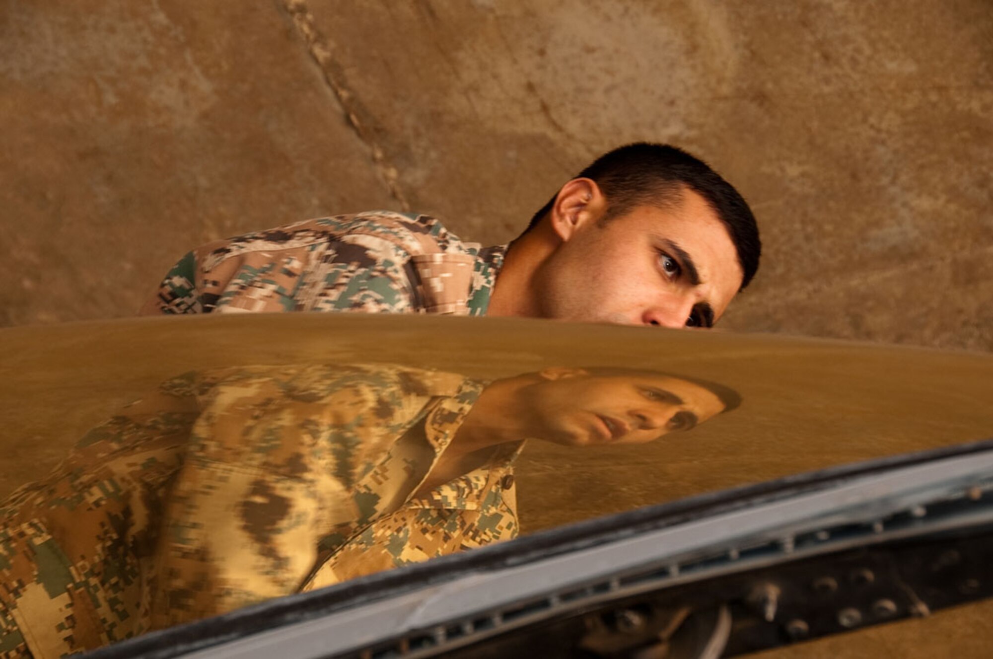 An airman from the Royal Jordanian Air Force inspects the canopy of an F-16 Fighting Falcon in preparation of flights that will be done later that day November 1, 2009, Mwaffaq Salti Air Base, Jordan, during Falcon Air Meet 2009.  The Falcon Air Meet is a friendly competition centered on the F-16 Fighting Falcon. F-16 units from Jordan, Belgium and the 169th Fighter Squadron from the South Carolina Air National Guard competed in this 4th annual event hosted in Jordan.  (U.S. Air Force photo by Tech. Sgt. Wolfram M. Stumpf) (Released)