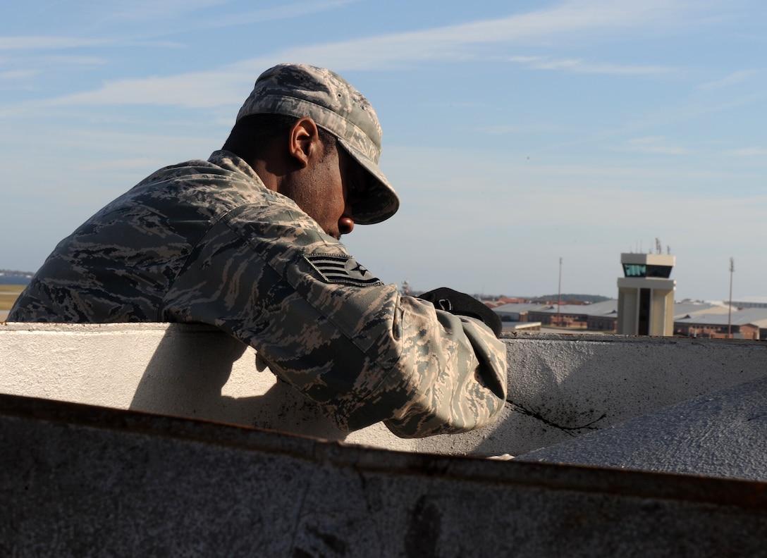 LANGLEY AIR FORCE BASE, Va. --  Staff Sgt. Sherman Armprester, 1st Civil Engineer Squadron structural craftsman, repairs a bent ventilation shaft Nov. 17. High winds and rain from a recent nor'easter damaged the shaft.  (U.S. Air Force photo/Senior Airman Zachary Wolf)    