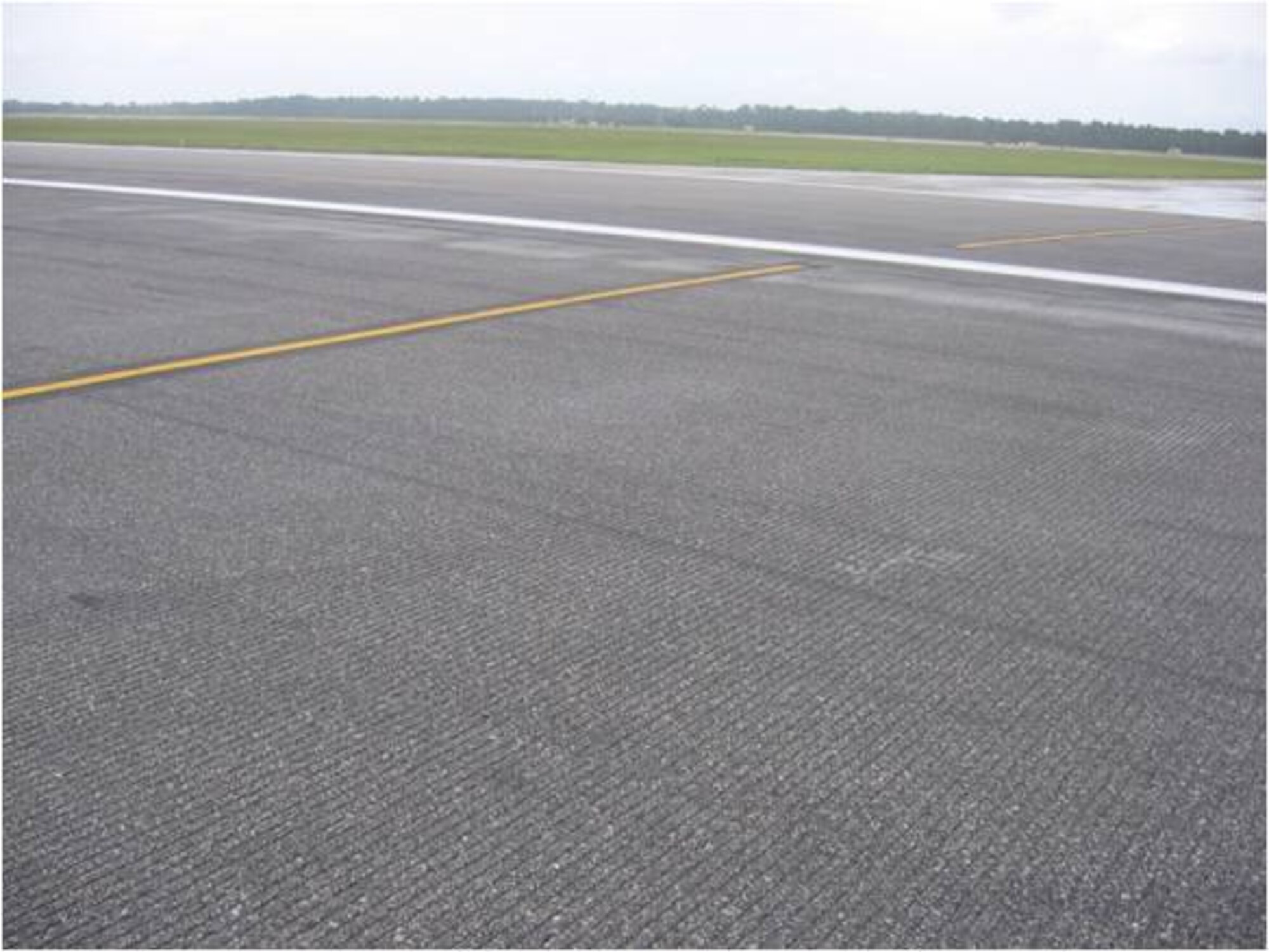 AFTER:The asphalt slurry seal on the inside of the runway, shown here, along with the rubber removal from both touchdown zones, cost $291,500 and was completed May 31. The money was part of the $23.3 million Tyndall received in April as part of the Recovery and Reinvestment Act. The act was part of the stimulus package signed by President Barack Obama on Feb. 17 to jumpstart the American economy. (U.S. Air Force courtesy photo)