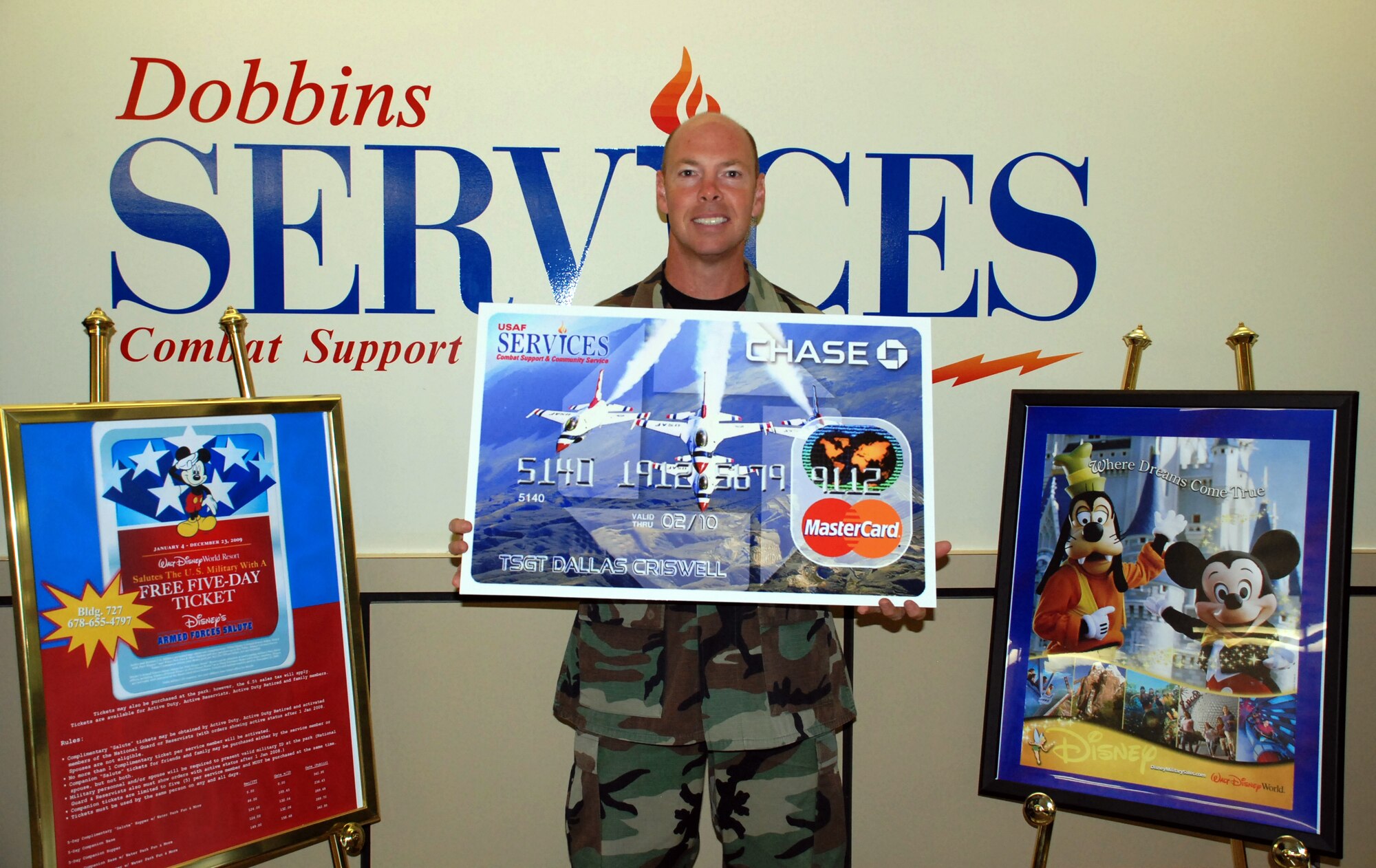Tech. Sgt. Dallas Criswell, 94th Operations Support Squadron, poses with a large replica of a $250 gift card he won after registering to become an Air Force Club member.  He won during a special Air Force wide contest for the 2009 Club Membership drive. To become an Air Force Club member, register online at www.afclubs.net.  "It pays to become a member." (U.S. Air Force photo/Priscilla Levister)