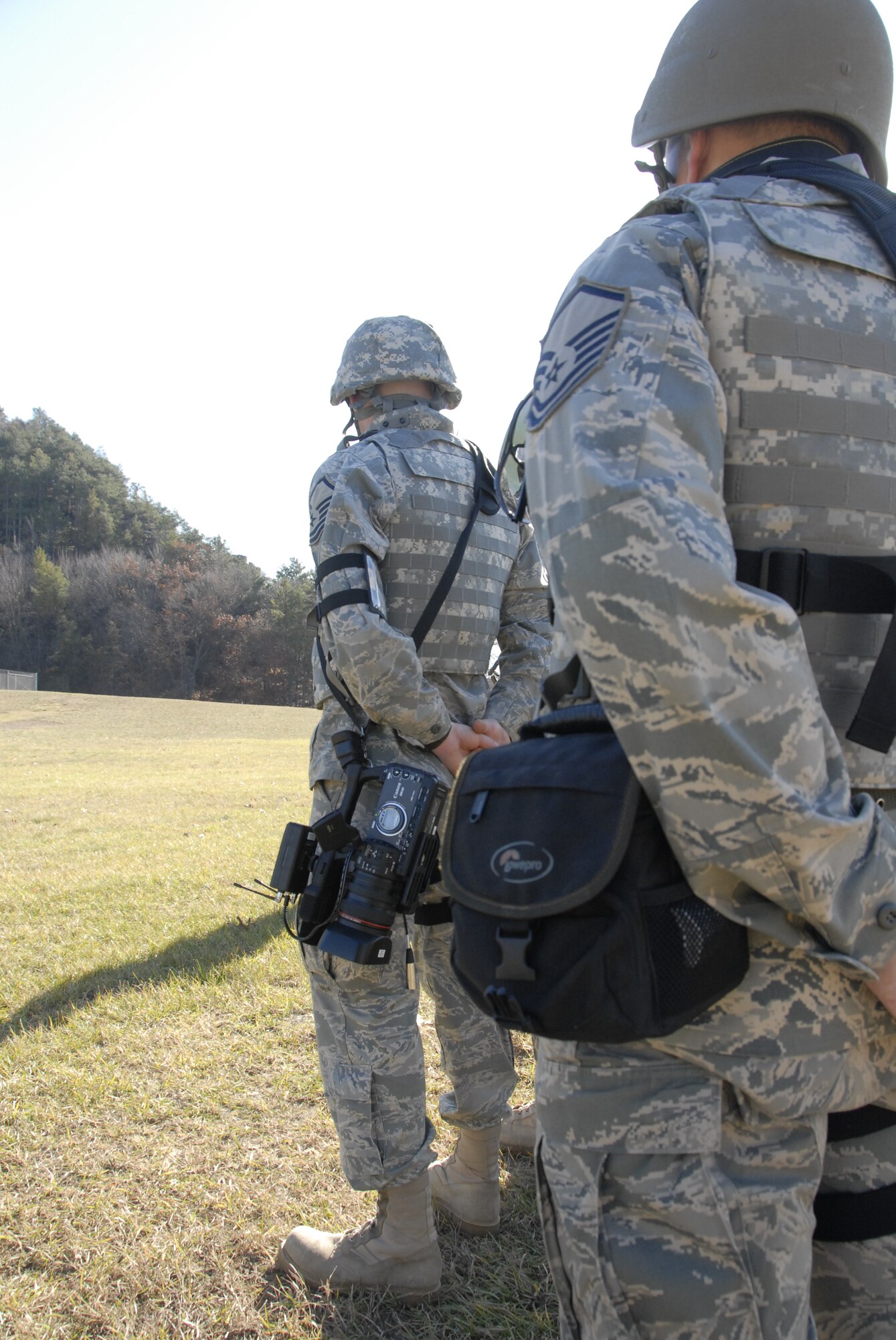 Master Sgt. Paul Gorman (right), along with Master Sgt. Dan Richardson, public affairs personnel from the 115th Fighter Wing in Madison, Wis., form up for roll call during a Security Forces exercise at Volk Field Combat Readiness Training Center Nov. 7, 2009. Three public affairs personnel from the 115th embedded with their own Security Forces to learn how to effectively operate under the pressures of a combat environment.  The training proved beneficial to both sides as SF members learned ways to protect embedded assets while performing their regular duties.  (U.S. Air Force Photo by Tech. Sgt. Don Nelson) 