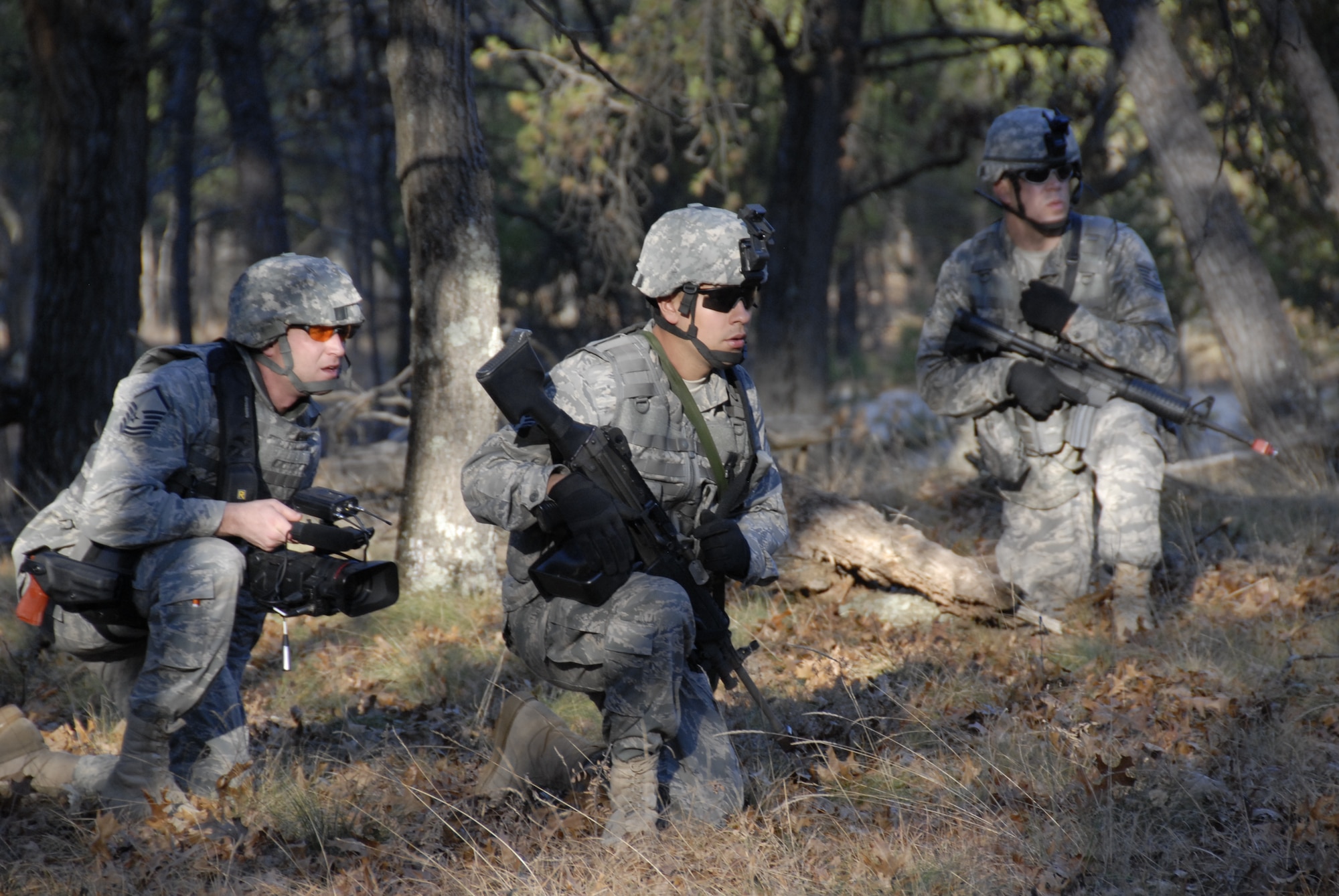 Master Sgt. Dan Richardson (left), broadcaster with the 115th Fighter Wing in Madison, Wis., looks on as Senior Airmen Nathan Ortiz (middle) and Tech Sgt. Kirk Flatten, Security Forces members assess a possible threat during a Security Forces exercise at Volk Field Combat Readiness Training Center Nov. 7, 2009. Three public affairs personnel from the 115th embedded with SF to learn how to effectively operate under the pressures of a combat environment.  The training proved beneficial to both sides as SF members learned ways to protect embedded assets while performing their regular duties.  (U.S. Air Force Photo by Tech. Sgt. Don Nelson)