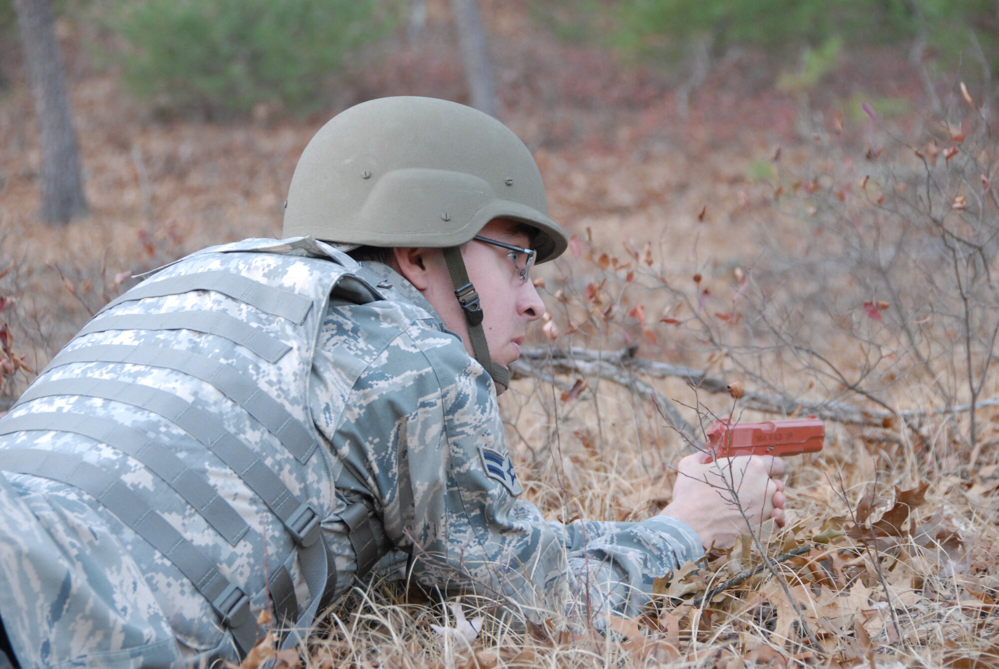 Airmen 1st Class Ryan Roth, journalist with the 115th Fighter Wing in Madison, Wis., watches his field of fire for threats during a Security Forces exercise at Volk Field Combat Readiness Training Center Nov. 7, 2009. Three public affairs personnel from the 115th embedded with SF to learn how to effectively operate under the pressures of a combat environment.  The training proved beneficial to both sides as SF members learned ways to protect embedded assets while performing their regular duties.  (U.S. Air Force photo by Master Sgt. Paul Gorman)