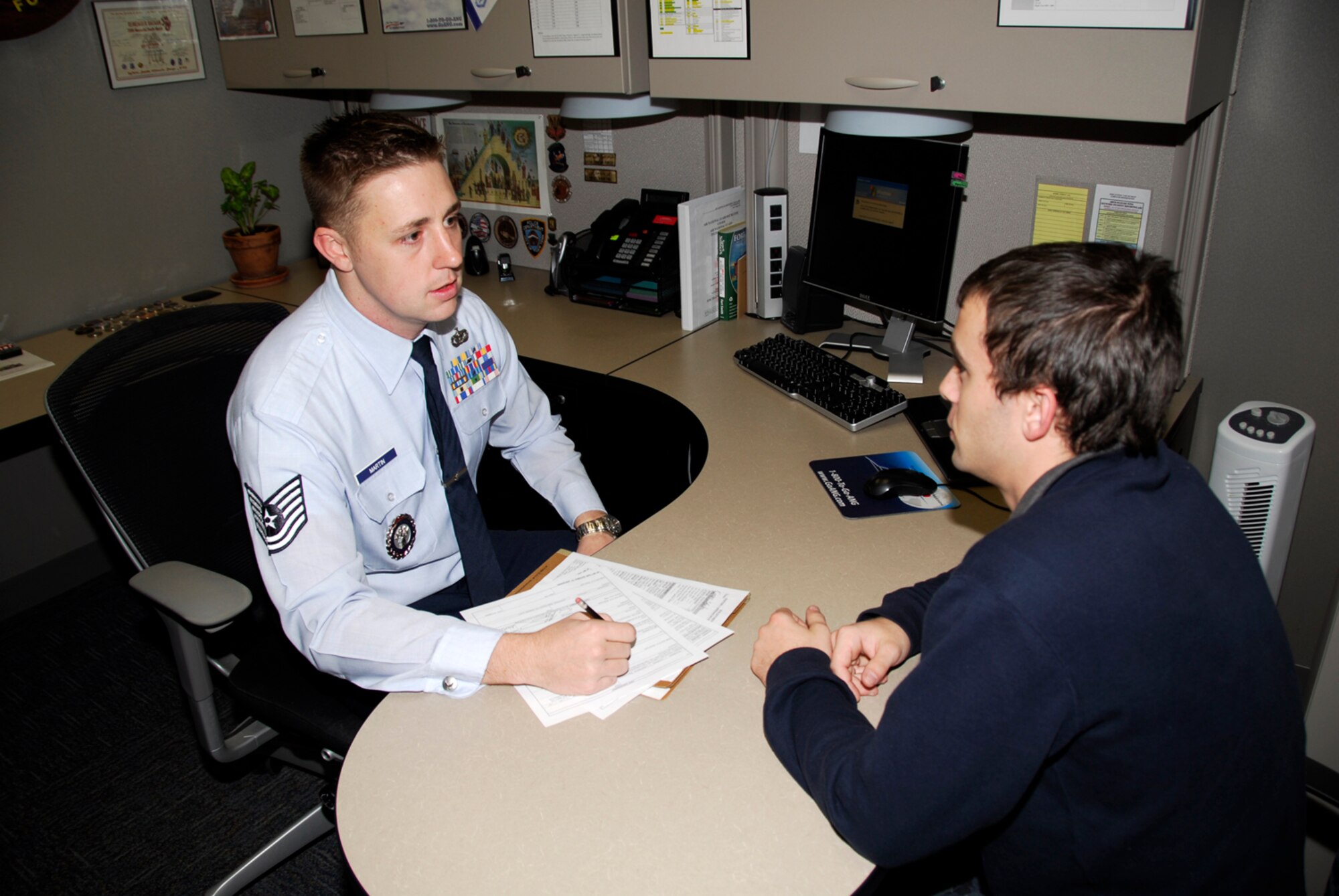 Tech Sgt. Eric Martin, left, speaks to a recruit at the 188th Fighter Wing Nov. 17, 2009. The 188th recruiting office earned the state award and Southeast Regional accolade for Outstanding Recruiting Office of the Year at the Arkansas Air National Guard Recruiting and Retention State Conference Oct. 29, 2009, in Mt. Ida, Ark. Martin earned the state and regional awards for Outstanding Rookie Recruiter of the Year. (U.S. Air Force photo by Senior Master Sgt. Dennis Brambl/188th Fighter Wing Public Affairs)