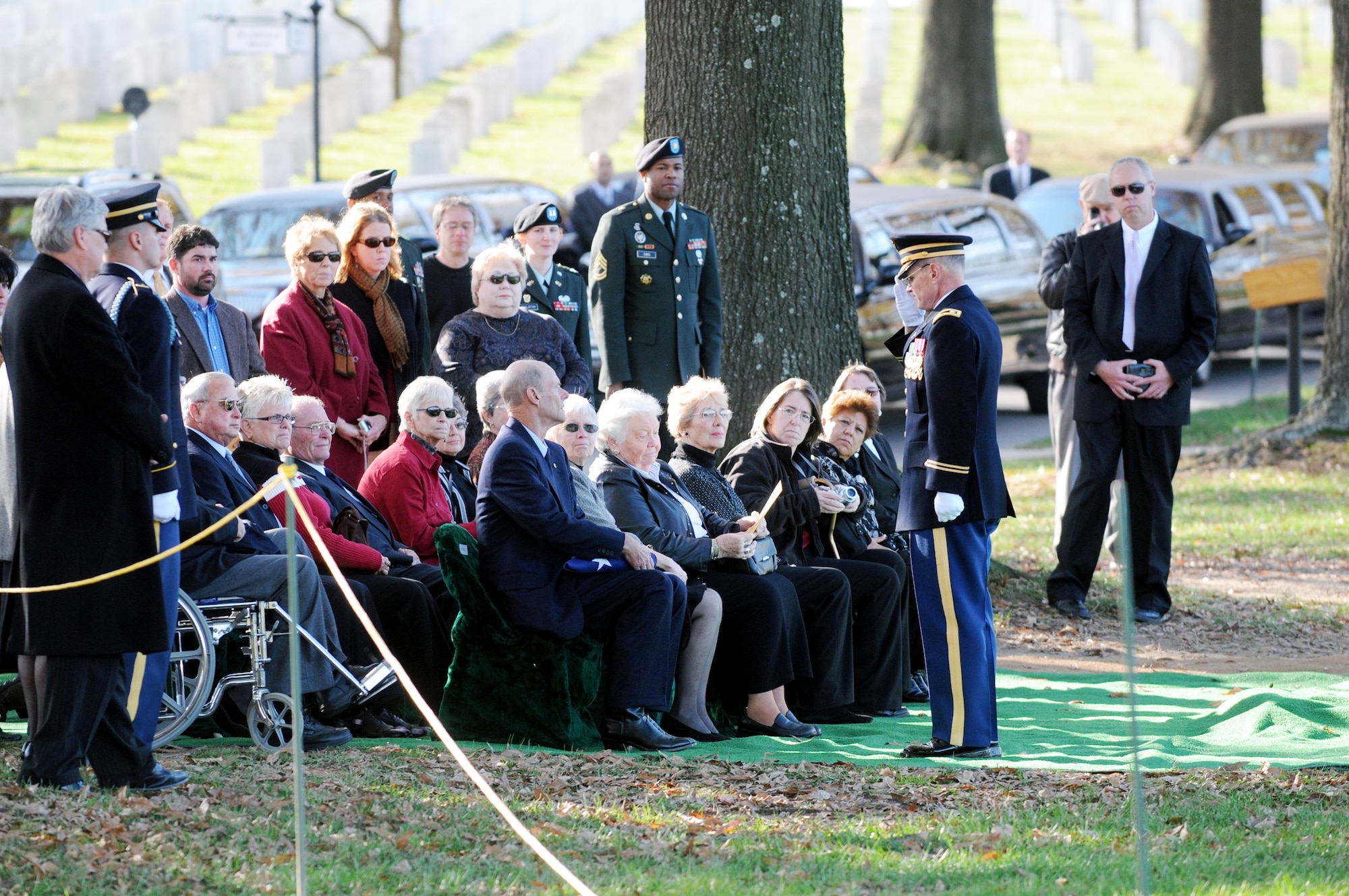 A high ranking military official salutes a family member after presenting the American flag at an internment ceremony for seven members of the  World War II B-25 aircrew that were lost Dec. 5, 1942, near Papua, New Guinea, at Arlington National Cemetery in Virginia Nov. 17, 2009. (Defense Department photo/Navy Petty Officer William Selby)