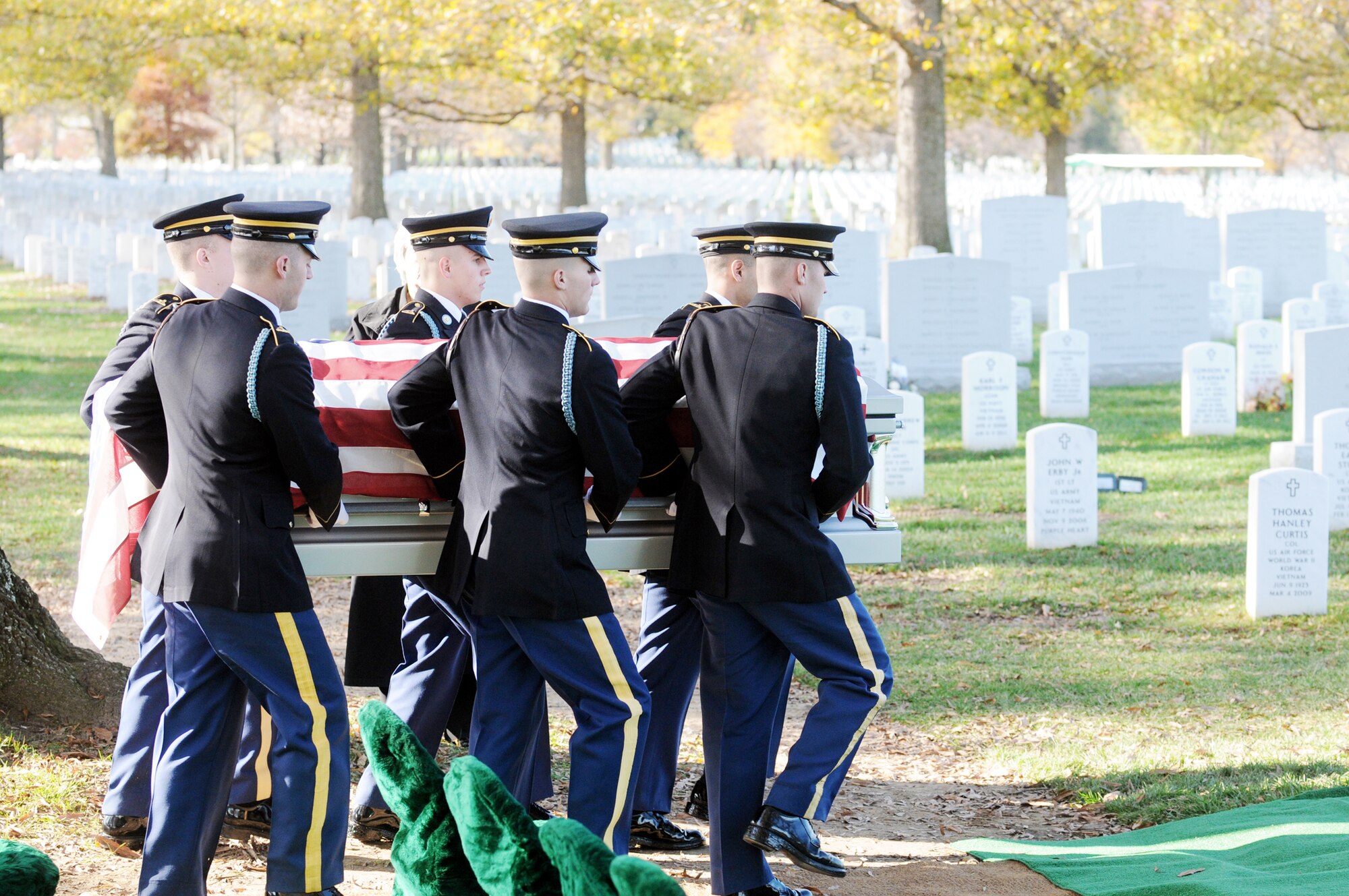 Several military members carry the remains of a fallen servicemember of the World War II B-25 aircrew that was lost Dec. 5, 1942 near Papua, New Guinea, at Arlington National Cemetery in Virginia. (Defense Department photo/Navy Petty Officer William Selby)