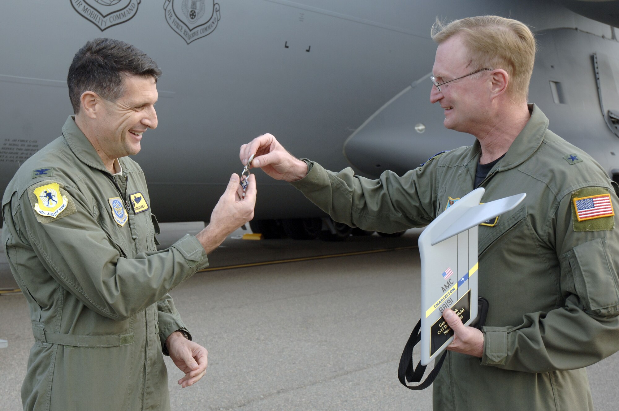 Brig.Gen. David Fadok, right, hands Col. Joe Mancy the keys to Charleston AFB's newest C-17 Nov. 17. The new arrival brings the total number of aircraft assigned to Charleston AFB to 59. General Fadok is the director for Policy and Strategy, Headquarters U.S. Southern Command and Colonel Mancy is the 437th Operations Group commander.  (U.S. Air Force photo/Staff Sgt. Marie Brown)