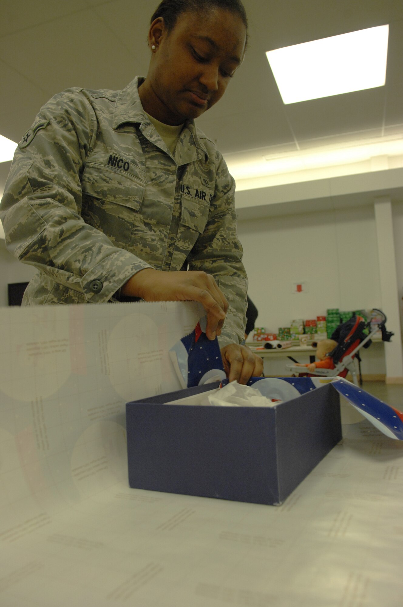 Airman Richelle Nico wraps a shoebox Nov. 12, 2009, Eielson Air Force Base, Alaska. Volunteers wrapped shoeboxs and filled them with candy, toys, and toiletries as part of Operation Christmas Child. Airman Nico is an emergency medical technician with the 354th Medical Group Flight Medicine flight. (U.S. Air Force photo/ Airman 1st Class Rachelle Coleman)