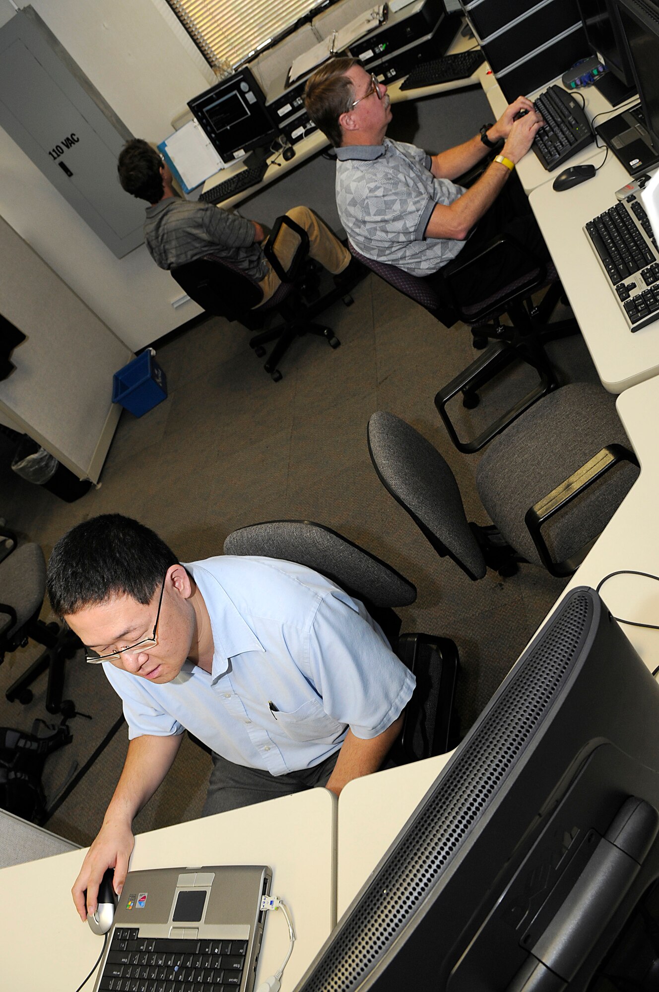 SCOTT AIR FORCE BASE, Ill. -- Joseph Tsai, computer engineer, Doug Sylar, information technology specialist and Bruce Betker, computer engineer with the Air Force Network Integration Center, perform risk analysis on computer systems and applications at Scott AFB, Oct. 26. The risk analysis is part of the Air Force Certification and Accreditation Program that evaluates COTS products and provides architecture implementation recommendations to Air Force Network Operations, I-NOSC and enclave information system owners to mitigate risks on the Air Force. (U.S. Air Force photo by Senior Airman Brian J. Ellis)