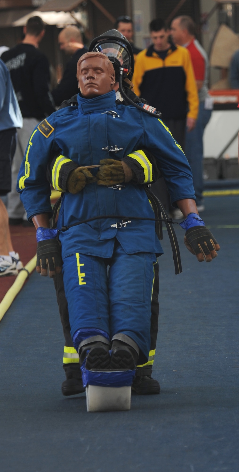 LAS VEGAS -- Senior Airman Megan Melanson, 509th Civil Engineer Squadron firefighter, drags the 175-pound dummy while on the final-leg of the 2009 Scott Firefighter Combat Challenge, Nov. 16. During the competition, the firefighters will climb a five-story tower, hoist and chop, drag hoses and rescue a "victim," while racing against themselves, their opponents, and the clock. (U.S. Air Force photo/Airman 1st Class Carlin Leslie)(Released)