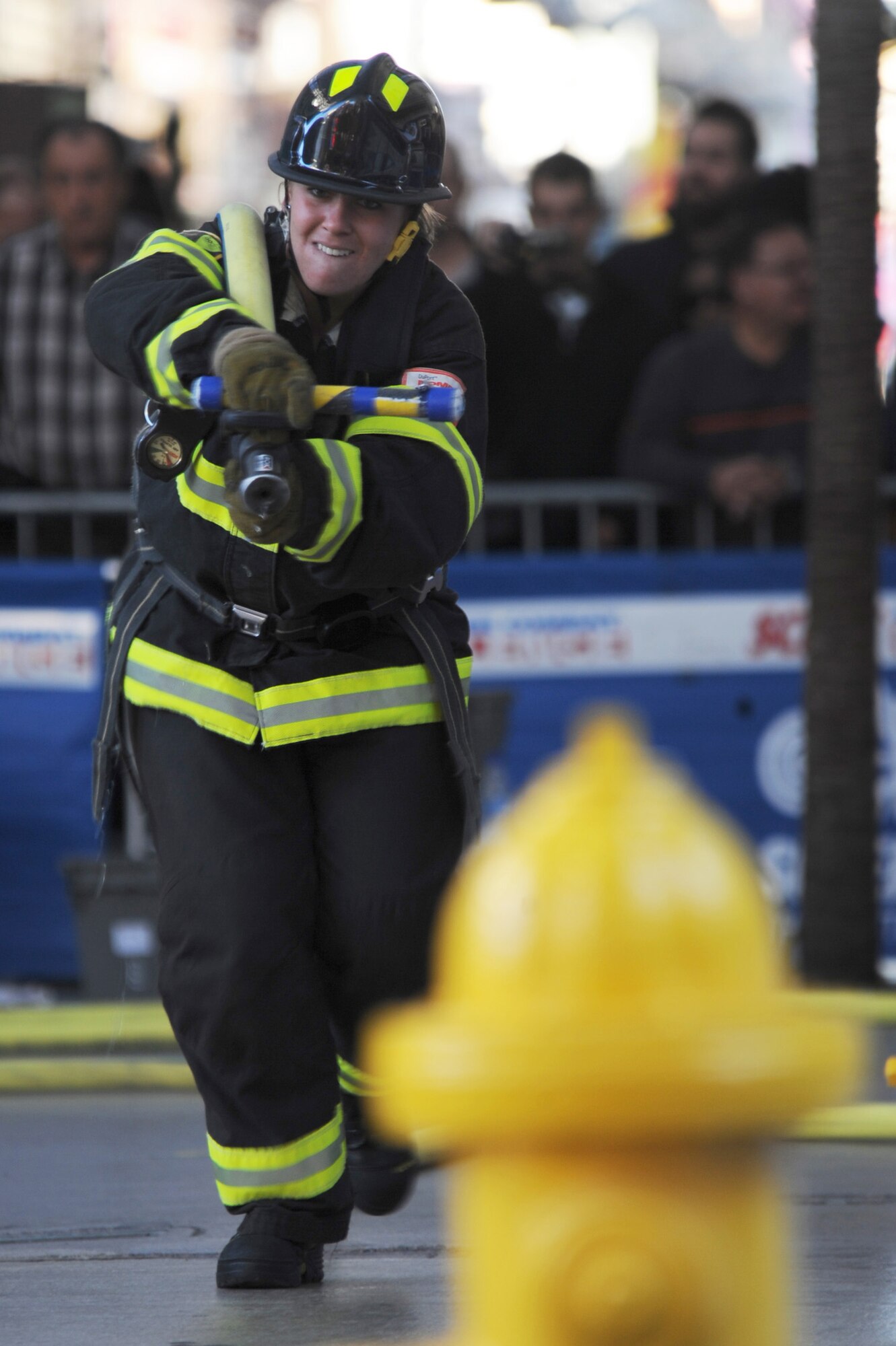 LAS VEGAS -- Senior Airman Megan Melanson, 509th Civil Engineer Squadron firefighter, competes in the 2009 Scott Firefighter Combat Challenge, in Las Vegas, by running her individual-run with the hose from the far end of the course in, Nov. 16. FFCC Worlds brings together teams from all over the world to show what they can do in a series of tasks that test their strength to the max.(U.S. Air Force photo/Airman 1st Class Carlin Leslie)(Released)