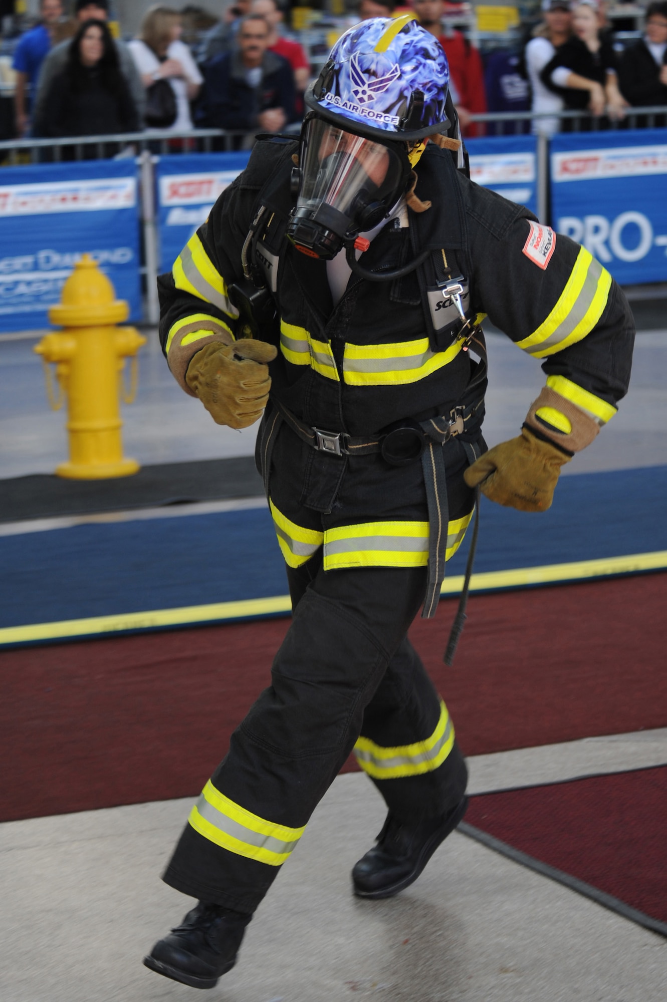 LAS VEGAS -- Airman 1st Class Dan Baumgartner, 509th Civil Engineer Squadron firefighter, runs through the hydrant portion of the 2009 Scott Firefighter Combat Challenge here in Las Vegas, Nov. 16. FFCC Worlds brings together teams from all over the world to show what they can do in a series of tasks that test their strength to the max.(U.S. Air Force photo/Airman 1st Class Carlin Leslie)(Released) 