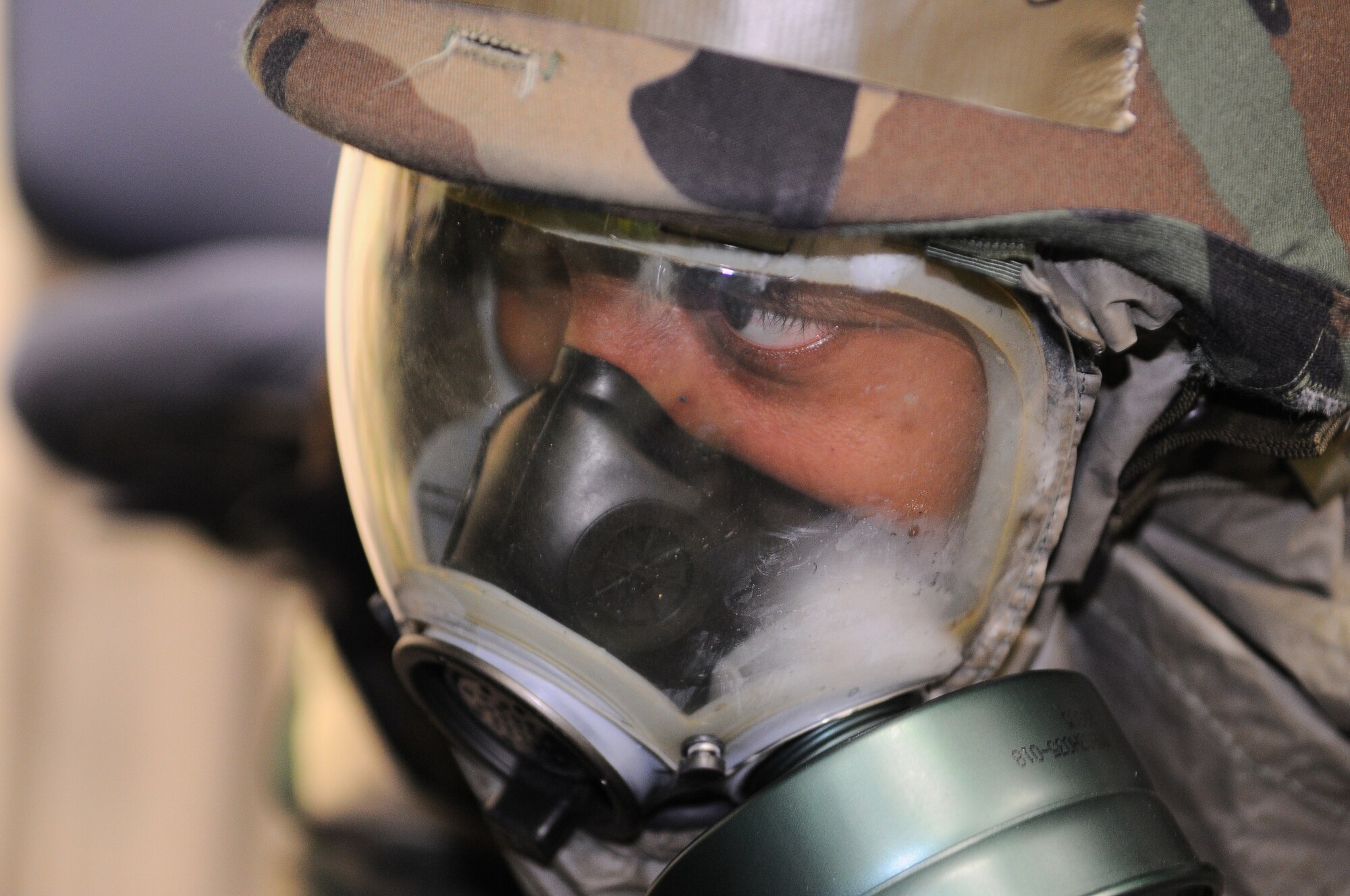 YOKOTA AIR BASE, Japan -- Airman 1st Class Raymond Young, 374th Force Support Squadorn, seeks shelter during an attack on Yokota during Phase II of Exercise Beverly Morning 10-01. Yokota is conducting an exercise Nov. 18 through Nov. 20 to maintain operational readiness. (U.S. Air Force photo/Airman 1st Class Michael Dillon)