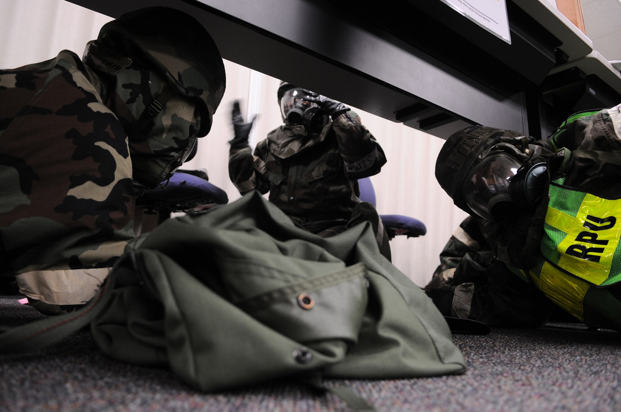 YOKOTA AIR BASE, Japan -- Members of the 374th Force Support Squadorn seek shelter during an attack on Yokota during Phase II of Exercise Beverly Morning 10-01. Yokota is conducting an exercise Nov. 18 through Nov. 20 to maintain operational readiness. (U.S. Air Force photo/Airman 1st Class Michael Dillon)