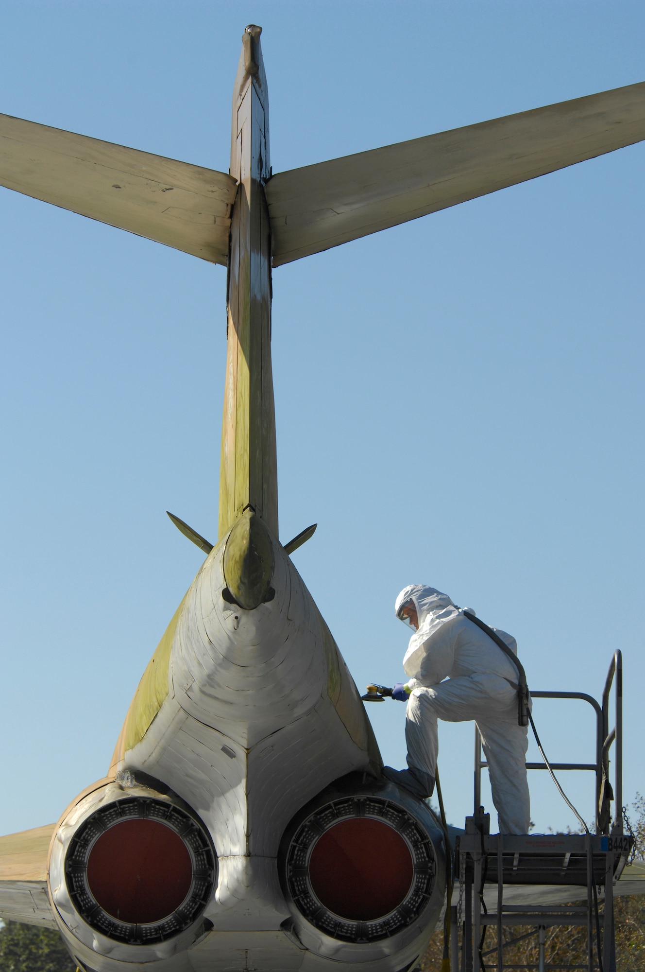 SHAW AIR FORCE BASE, S.C. -- Airman 1st Class Daniel Ricci, 20th Equipment Maintenance Squadron aircraft structural maintenance, sands off the paint of an RF-101 Voodoo aircraft, Oct. 12. The aircraft is an Air Force Museum asset and is required to be maintained. This maintenance includes washing the craft  periodically, maintaining structural integrity and refurbishing. (U.S. Air Force photo / Senior Airman Kathrine McDowell) 