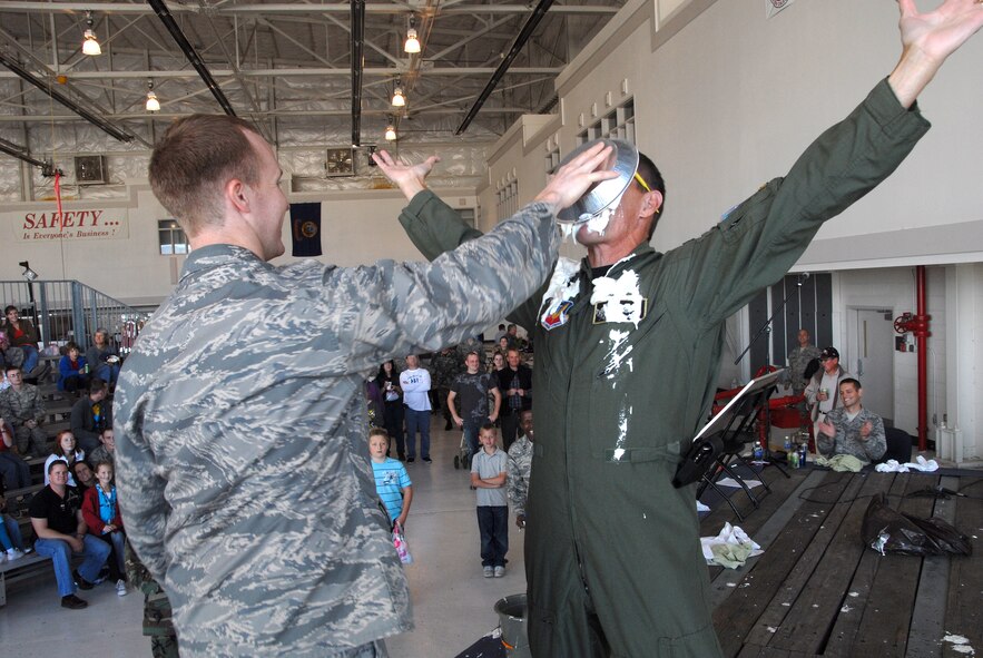 Col. J.R. Compton, 124th Fighter Wing Commander, takes a pie in the face from his son Capt. Joseph Compton as part of a wing-wide fund raiser for the Combined Federal Campaign. The auctioned event held during the wing's Family Day Picnic Oct.18 raised more than of $3,600. (Air Force photo by Tech. Sgt. Becky Vanshur)(Released)