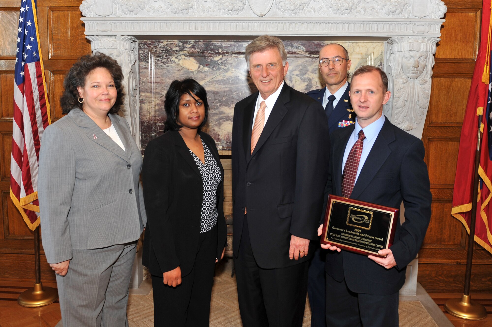 Arkansas Gov. Mike Beebe presented the Governor's Leadership and Fitness Award Nov. 13 to members of the 19th Medical Group’s Health and Wellness Center for outstanding contributions in the promotion of physical activity. Pictured from left to right are Celeste Williams, information manager; Kim Dean, health education manager; Governor Beebe; Lt. Col. Thomas Morrison, 19th Aerospace Medicine Squadron commander, and Jeffrey Vaughn, fitness program manager. (U.S. Air Force photo by Staff Sgt. Chris Willis)