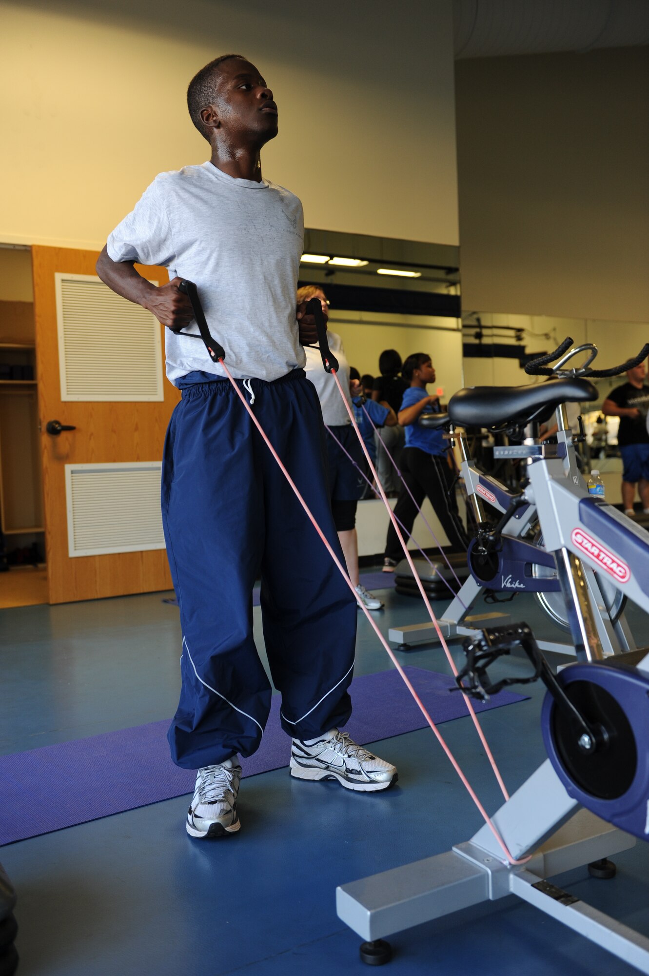 Airman 1st Class Nathaniel Edwards, 314th Maintenance Operations Squadron, performs a standing row with resistance bands during a burn hour session at the fitness center Nov. 3. The Health and Wellness Center won the Governor's Leadership and Fitness Award for outstanding contributions in the promotion of physical activity. (U.S. Air Force photo by Senior Airman Jim Araos)
