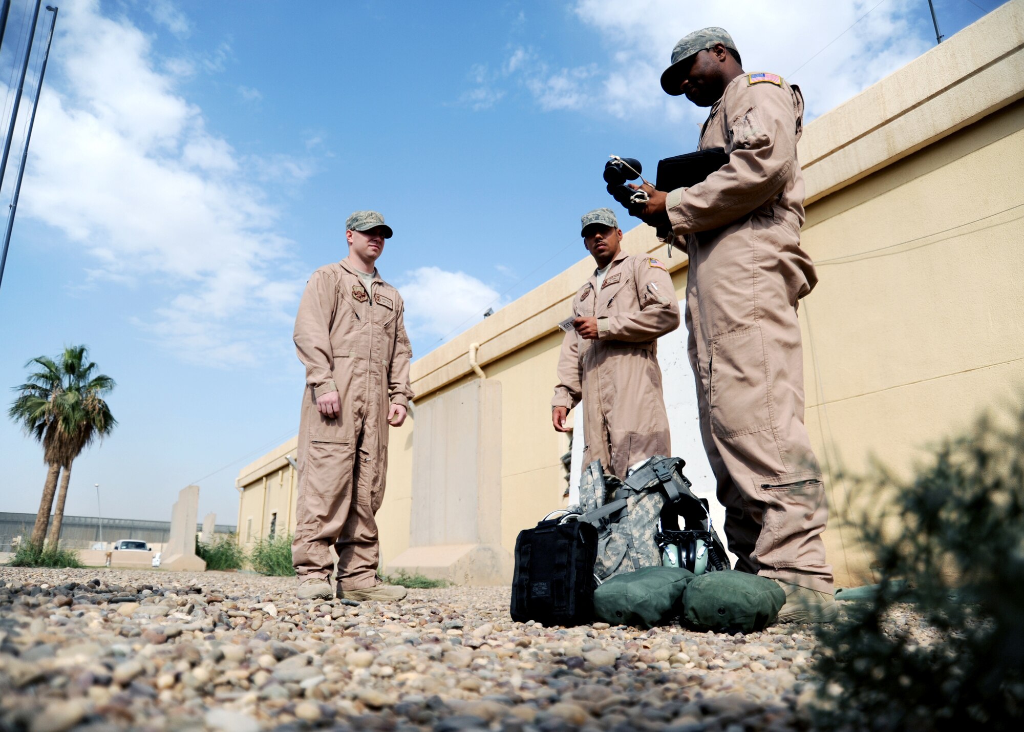 JOINT BASE BALAD, Iraq -- Staff Sgt. Rafeal Strother, Staff Sgt. Chris Amor and Senior Airman Bryan Malia, 332nd Expeditionary Security Forces Squadron fly-away security team members, inspect their group kits prior to a fly away security mission Nov. 13, 2009. The group kit contains essential items to complete the mission, in a variety of situations. (U.S. Air Force photo/Senior Airman Christopher Hubenthal)