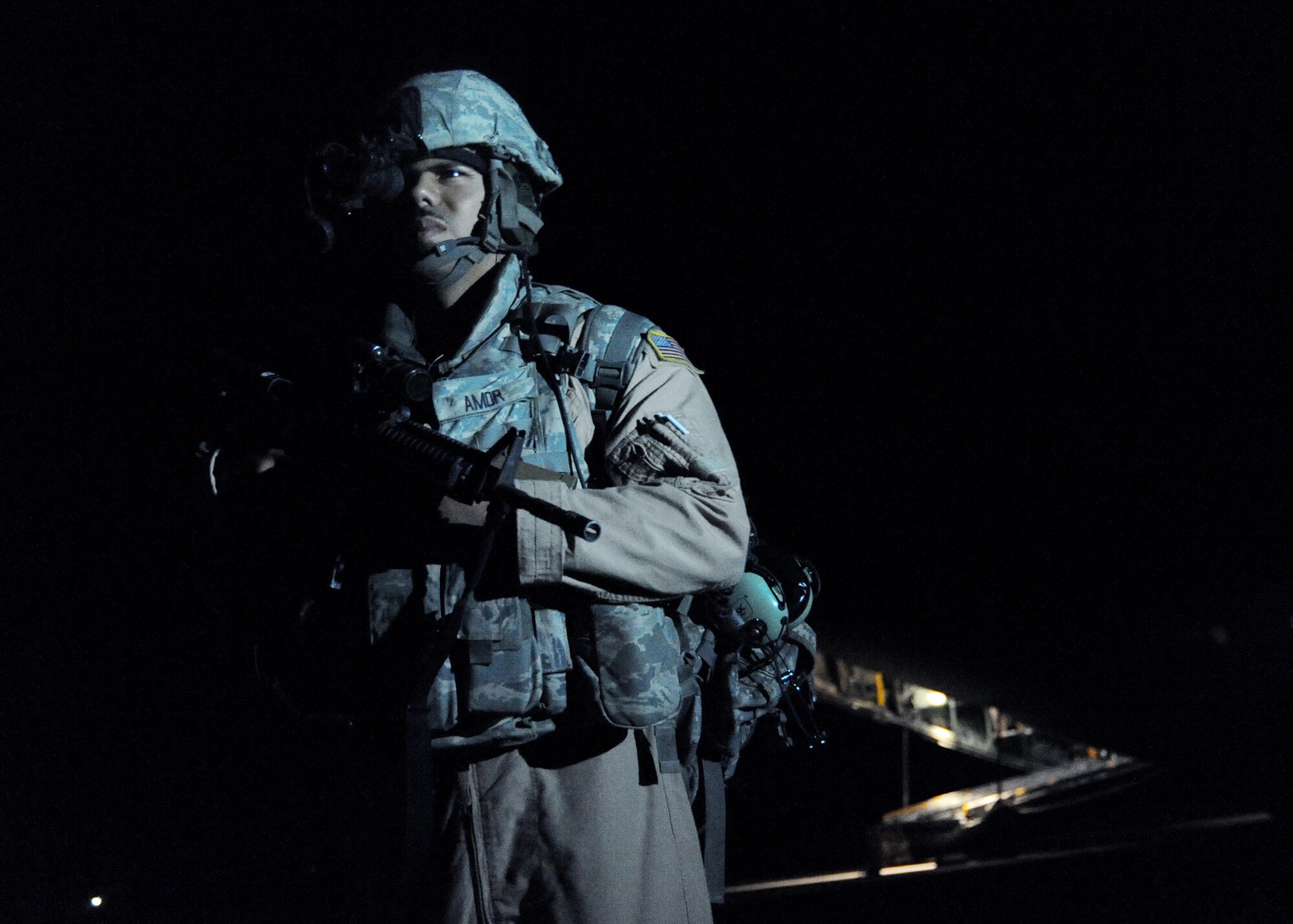 JOINT BASE BALAD, Iraq -- Staff Sgt. Chris Amor, 332nd Expeditionary Security Forces Squadron fly-away security team leader, scans his designated area as cargo is loaded on a C-130 Hercules at Qayyarah Airfield West, Iraq Nov. 13, 2009. The FAS team provides ground security, resources and crewmembers to neutralize possible threats to U.S. aircraft at airfields throughout the area of responsibility. (U.S. Air Force photo/Senior Airman Christopher Hubenthal)