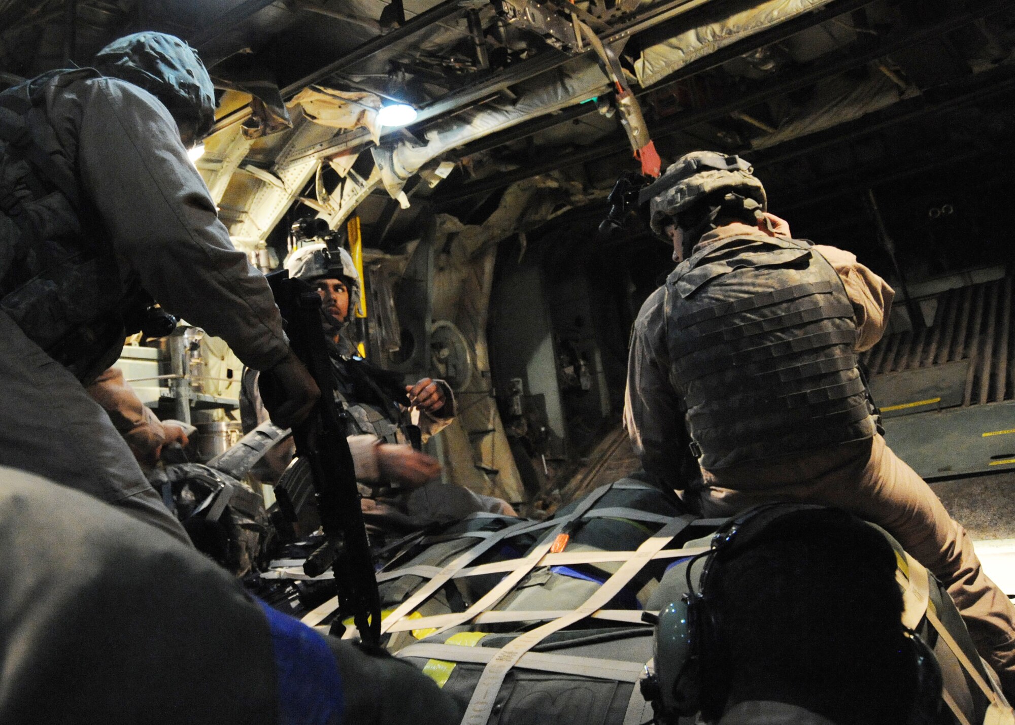 JOINT BASE BALAD, Iraq -- Staff Sgt. Rafeal Strother, Staff Sgt. Chris Amor and Senior Airman Bryan Malia, 332nd Expeditionary Security Forces Squadron fly-away security team members, prepare to provide ground security for a C-130 Hercules at Qayyarah Airfield West, Iraq Nov. 13, 2009. The FAS team is trained to deny access to essential areas around an aircraft to unauthorized individuals on airfields throughout the area of responsibility that require extra security. (U.S. Air Force photo/Senior Airman Christopher Hubenthal)