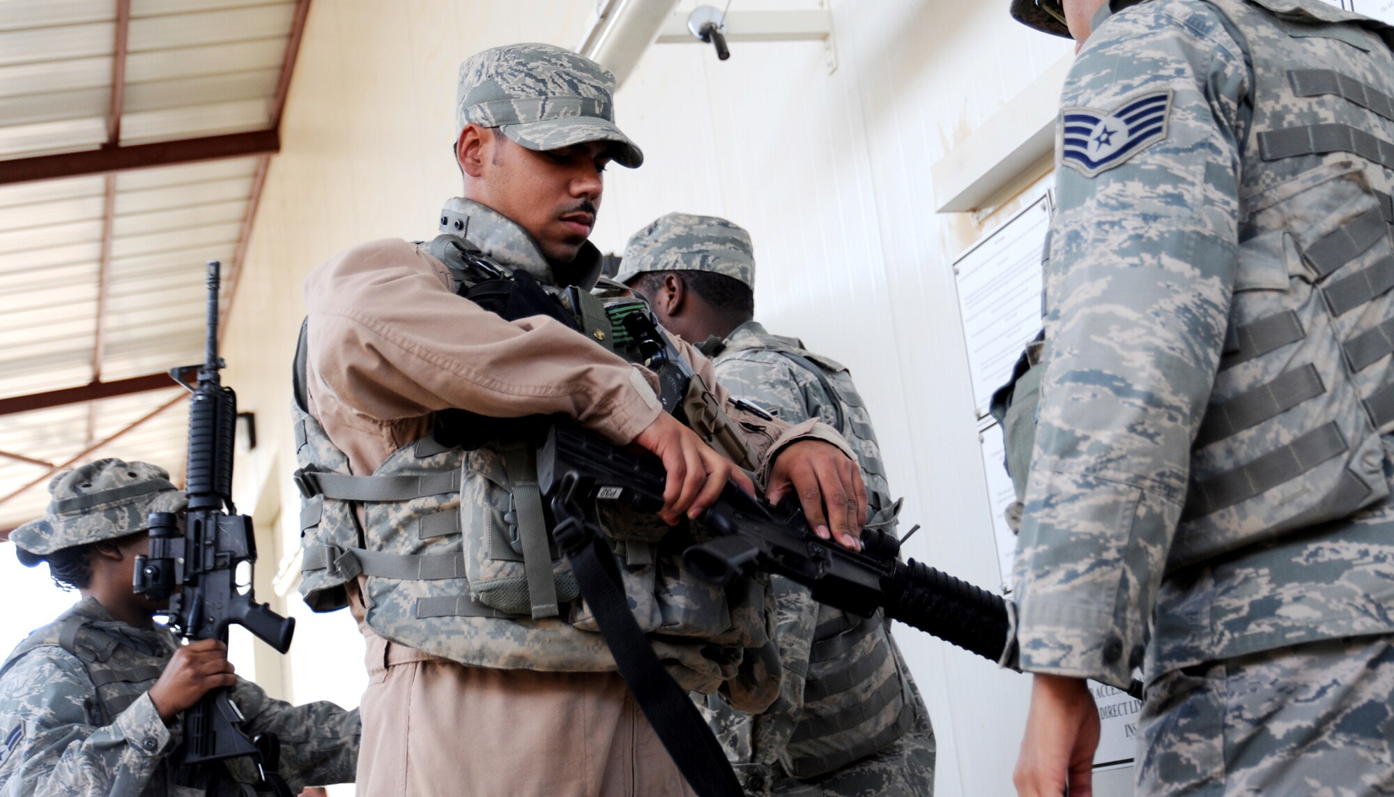 JOINT BASE BALAD, Iraq -- Staff Sgt. Chris Amor, 332nd Expeditionary Security Forces Squadron fly-away security team leader, clears his weapon prior to a mission Nov. 13, 2009. The FAS team provides ground security, resources and crewmembers to neutralize possible threats to U.S. aircraft at airfields throughout the area of responsibility. (U.S. Air Force photo/Senior Airman Christopher Hubenthal)