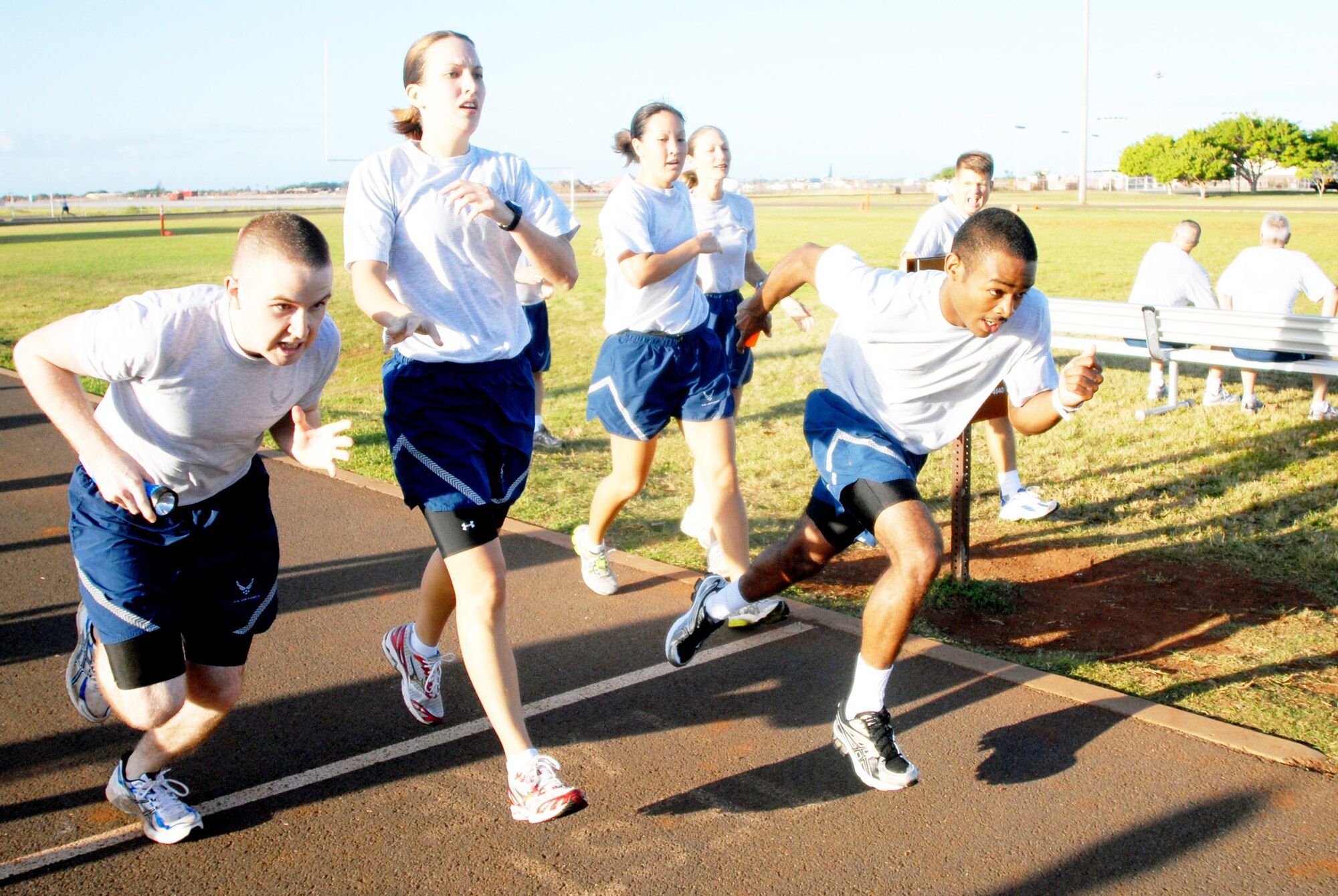 Members of 13th Air Force pass batons while competing in a relay race during Jungle Day Nov. 13, 2009, at Hickam Air Force Base, Hawaii. The Jungle Day tradition originated when the organization was assigned to Andersen AFB, Guam, and gives 13th Air Force members a chance to have fun and give back to the local community. (U.S. Air Force photo/Senior Airman Gustavo Gonzalez)