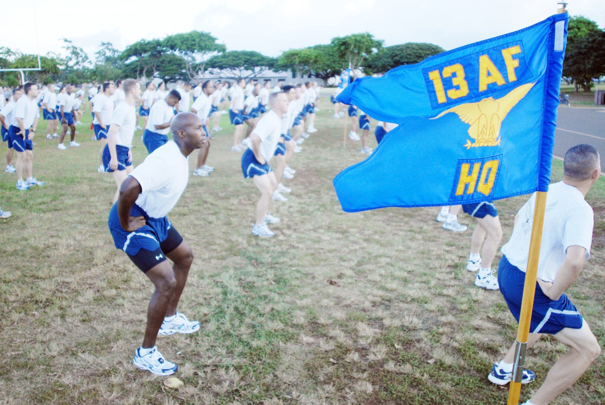 Members of 13th Air Force warm up before a warrior run during Jungle Day Nov. 13, 2009, at Hickam Air Force Base, Hawaii. The Jungle Day tradition originated when the organization was assigned to Andersen Air Force Base, Guam, and gives 13th Air Force members a chance to have fun and give back to the local community. (U.S. Air Force photo/Senior Airman Gustavo Gonzalez)