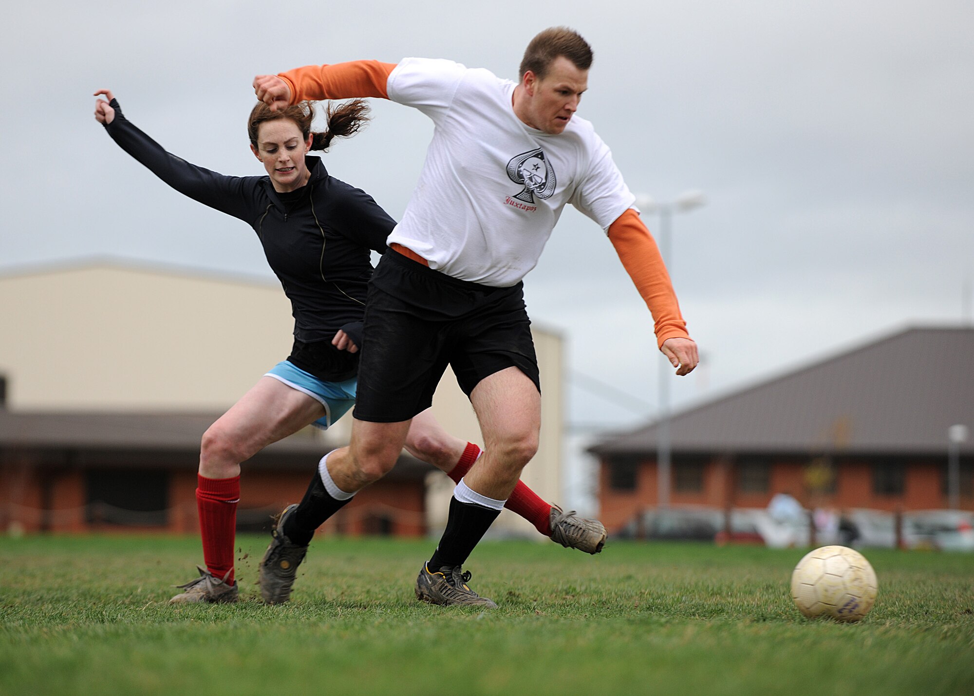 RAF MILDENHALL, England – Steve Alverson, the 488th Intelligence and 95th Reconnaissance Squadrons match winner skips pass 100th Force Support Squadrons Bethany Mettes, in the semi-final of the intramural soccer match at the Hardstand Fitness Center Nov. 18. The 488th IS/95th RS won the game 1-0 after a great solo goal from Alverson.  (U.S. Air Force photo/Staff Sergeant Jerry Fleshman) 