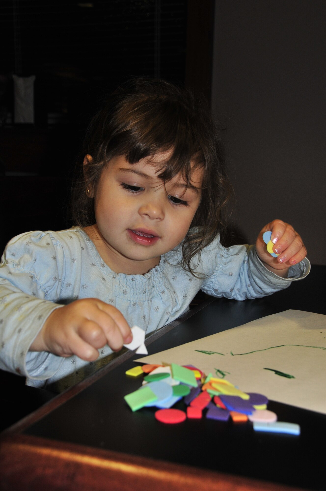 Ava Philip, age 3, picks out some art to use on her holiday card during a Yellow Ribbon dinner at the Seymour Johnson Air Force Base Southern Eagle Dining Hall, Nov. 12, 2009. Ava is the daughter of Sandy and Tech. Sgt. JasonJames Philip, 4th Maintenance Operations Squadron quality assurance inspector. The Airman & Family Readiness Center offers programs not only for Airmen but also for their families.  Other A&FRC programs include Readiness Emergency Sleep Tool pillow, Car Care Because We Care, Give Parents A Break and financial aid. (U.S. Air Force photo/Tech. Sgt. Lesley Waters)