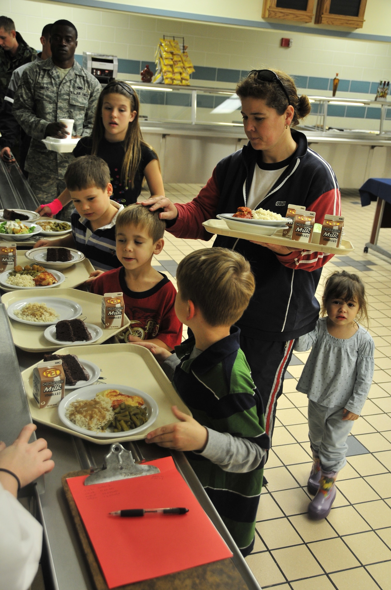 Sandy Philip, wife of Tech. Sgt. JasonJames Philip, 4th Maintenance Operations Squadron quality assurance inspector, waits to pay for her family’s meals during a Yellow Ribbon dinner at the Seymour Johnson Air Force Base Southern Eagle Dining Hall, Nov. 12, 2009. More than 15 families attended the bi-monthly dinner, which is open to families with a spouse deployed or serving on a remote assignment.  (U.S. Air Force photo/Tech. Sgt. Lesley Waters)