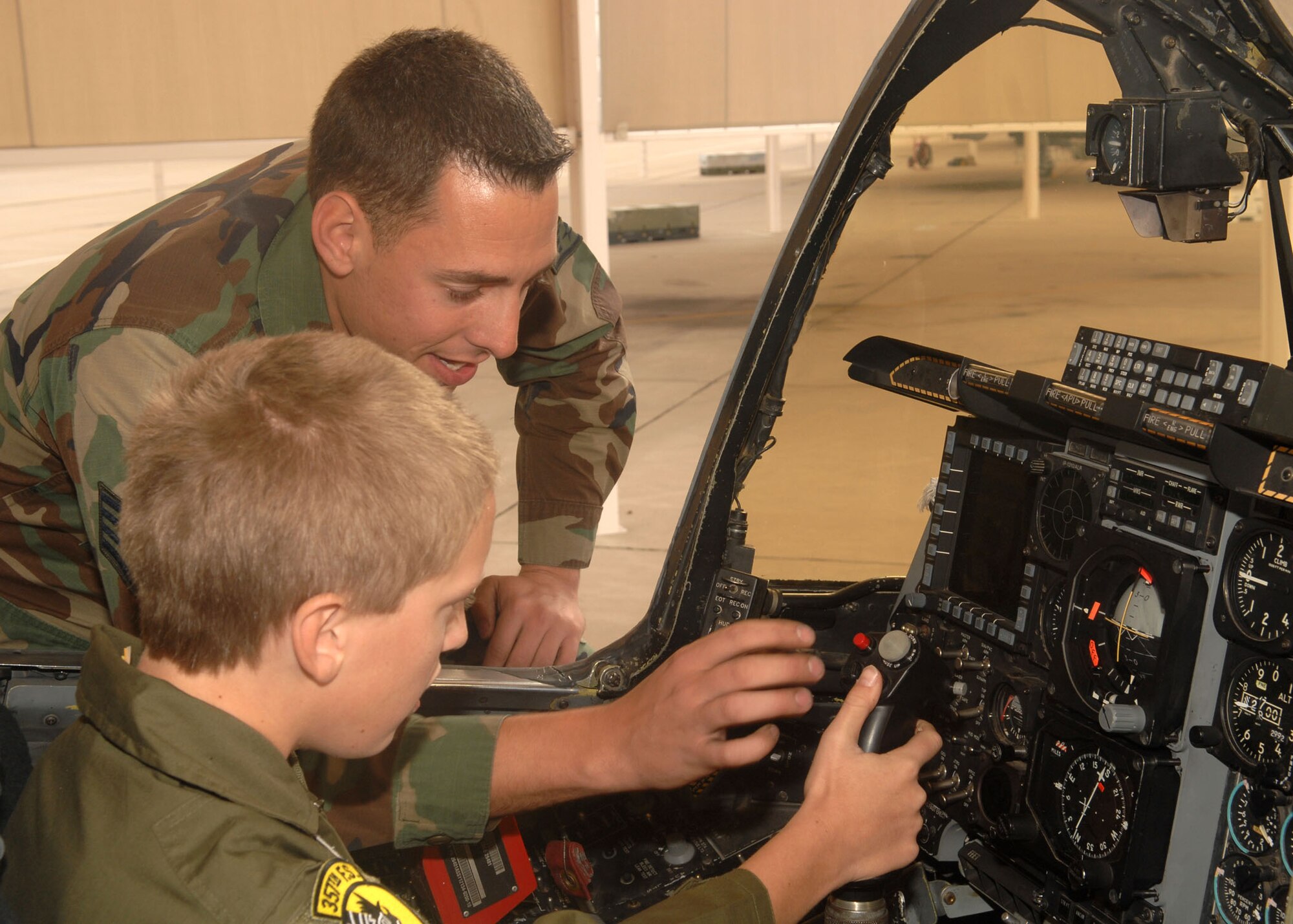 Staff Sgt. Joel Hamm, 355th Aircraft Maintenance Squadron, explains some of the inner workings of an A-10 Thunderbolt to Jake McKay, Pilot for a Day participant, Nov. 13. The Pilot for a Day program was designed to help children with disabilities or serious illnesses enjoy a day focused on them and their interest in aviation. (U.S. Air Force photo/Airman Jerilyn Quintanilla)
