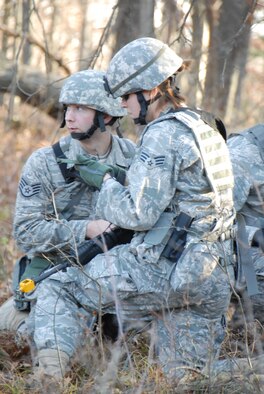 Senior Airman Leigh Downing (right), fire team member with the 115th Fighter Wing Security Forces pauses to relay coordinates to her squad leader Staff Sgt Adam Dax, during a combat training exercise at Volk Field, Air National Guard Base, Camp Douglas, Wis. Nov. 7, 2009The Madison, Wis. based 115th Security Forces Squadron engaged in a variety of combat training exercises as part of their November Unit Training Assembly. (U.S. Air Force photo by Master Sgt. Paul Gorman)