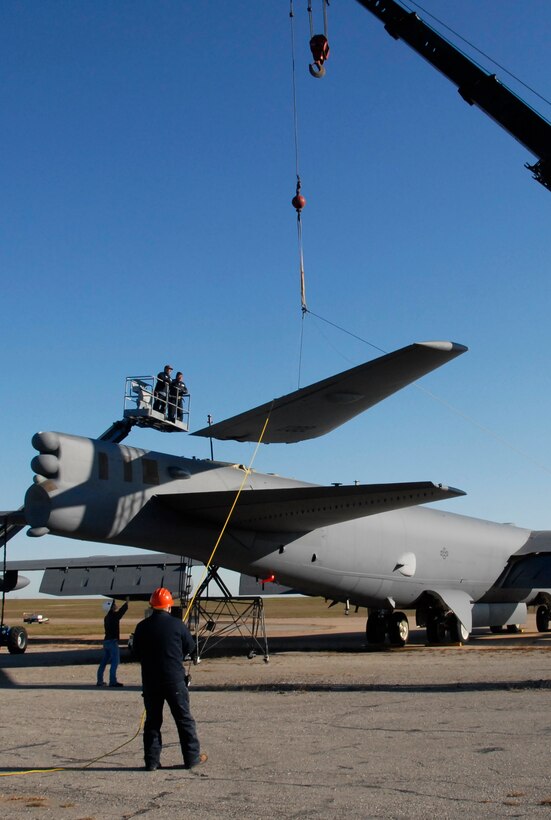A B-52H Stratofortress vertical fin is removed Nov. 17 at the old SAC ramp to convert into a trainer. This B-52H was part of the first task force to Afghanistan after Sept. 11, 2001, and it has nose art in memory of the event and those who lost their lives. (U.S. Air Force photo/ Mike Litteken)