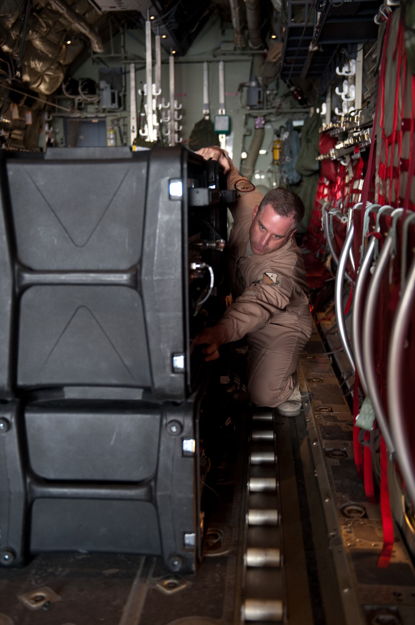 Master Sgt. Bryan Doyea, 379th Expeditionary Communications Squadron Viper Team member, sets up and prepares a Viper communications package aboard a C-130 Hercules, Nov. 16, 2009, in Southwest Asia. The Viper team provides secure and non-secure communications aboard aircraft for top officials traveling throughout the U.S. Central Command area of responsibility in support of operations Iraqi Freedom and Enduring Freedom. (U.S. Air Force photo/Staff Sgt. Robert Barney) 