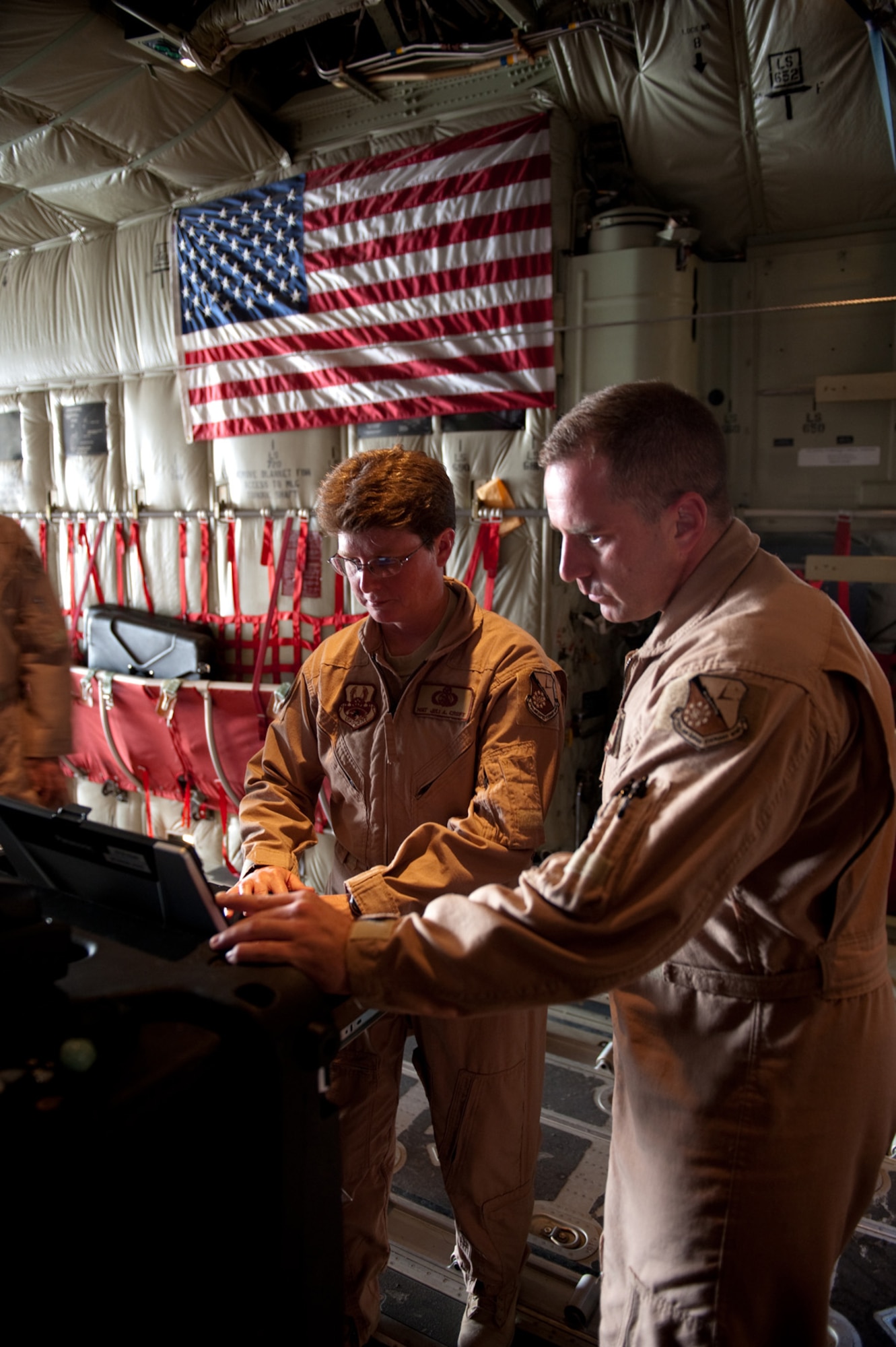 SOUTHWEST ASIA - Master Sgts. Juli Crost and Bryan Doyea, 379th Expeditionary Communications Squadron Viper Team members, set up and prepare a Viper communications package aboard a C-130 Hercules, Nov. 16, 2009, in Southwest Asia. The Viper team provides secure and non-secure communications aboard aircraft for top officials traveling throughout the U.S. Central Command area of responsibility in support of operations Iraqi Freedom and Enduring Freedom. (U.S. Air Force photo/Staff Sgt. Robert Barney) 