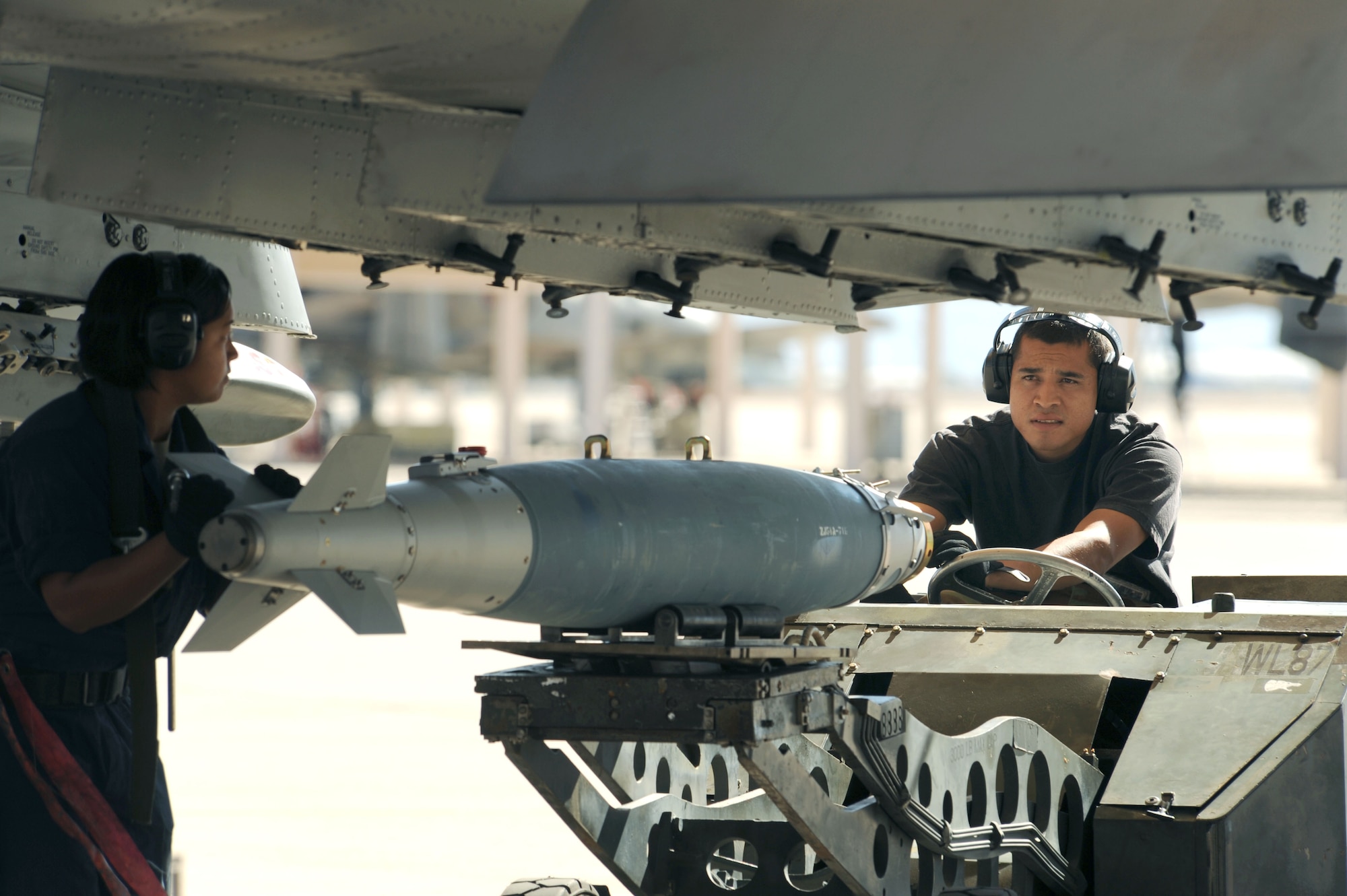 Staff Sgt. Juliet Cruz and Staff Sgt. Kevin Semallie, 355th Aircraft Maintenance Squadron weapons load crew team, reload an A-10 with a Guided Bomb Unit, GBU-38 (inert) following a sortie, upgrading the pilot for his next mission's requirements. The squadron generates all combat and training sorties in the 355th Fighter Wing by managing the efforts of Airmen in 13 different specialties who maintain A/OA-10 attack aircraft. The 355th AMXS provides safe, properly configured aircraft in order to meet the flying-hour program for three fighter squadrons. (U.S. Air Force photo/Staff Sgt. Valerie Smith)   
 
