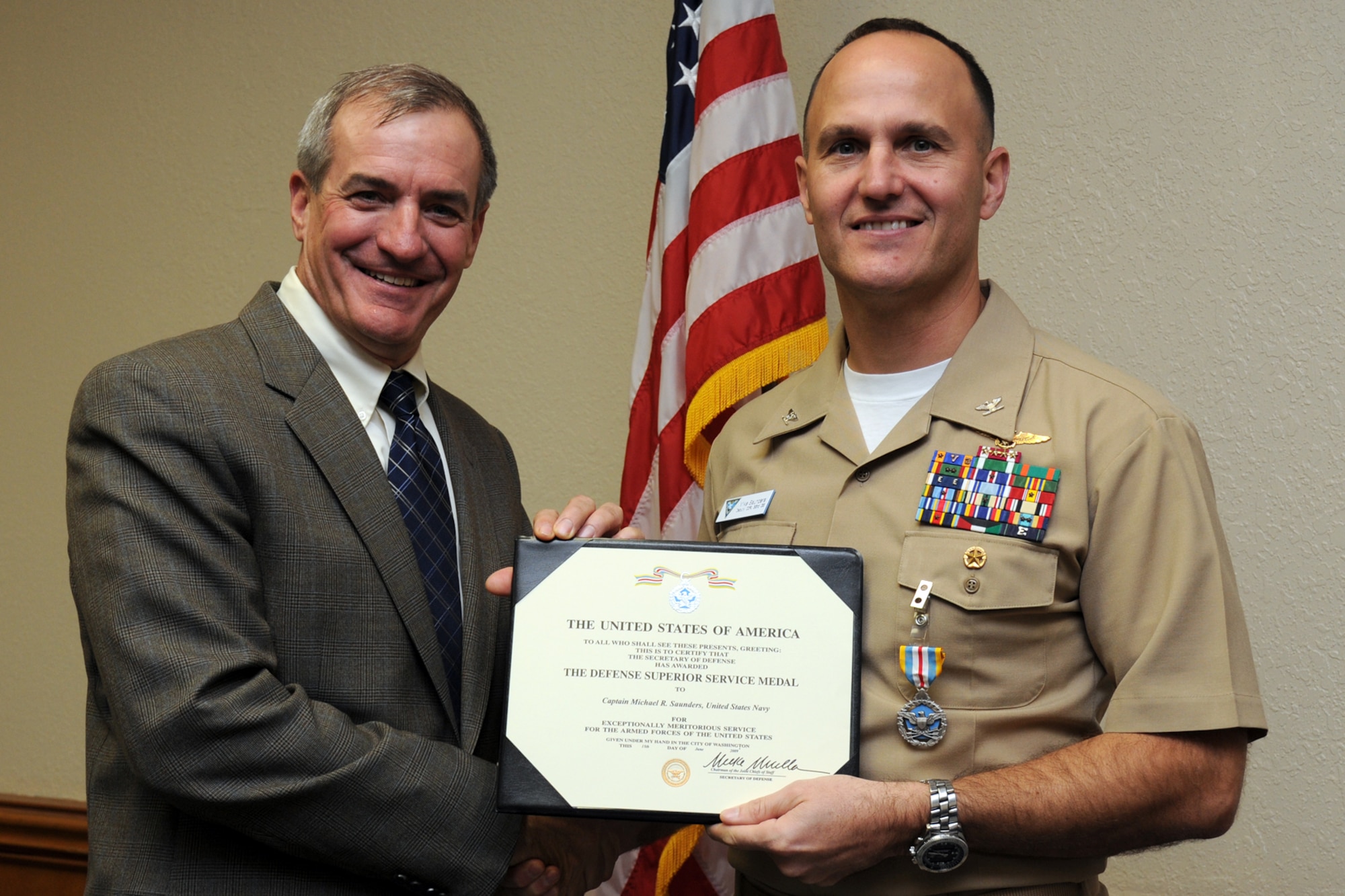 EGLIN AIR FORCE BASE, Fla. -- Kenneth Callicutt, Director of Capability and Resource Integration, presents Navy Capt. Mike Suanders, 33rd Operations Group deputy, the Defense Superior Service Medal Nov. 16 at the 33rd Fighter Wing. (U.S. Air Force photo/ Airman 1st Class Anthony Jennings)