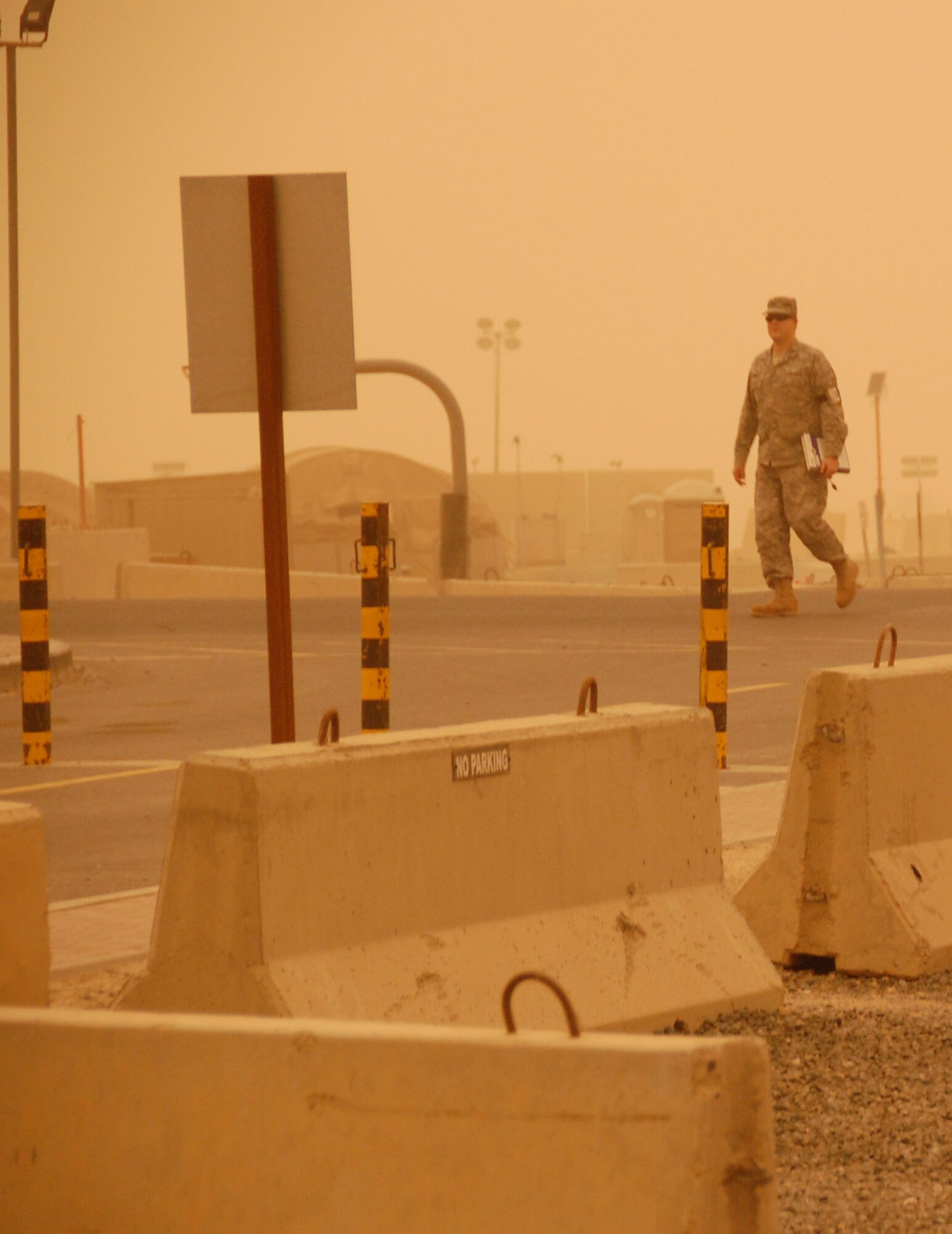 SOUTHWEST ASIA - An Airman here at the 386th Air Expeditionary Wing heads for cover when a dust storm passed through the region the afternoon of Nov. 17, 2009 (U.S. Air Force Photo/Capt. Larry van der Oord)